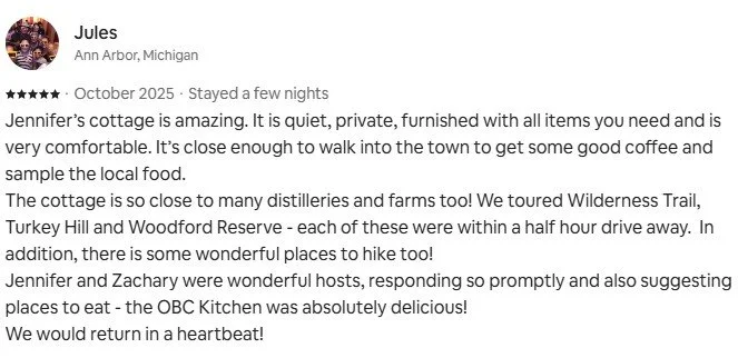 Screenshot of a review written by Jules from Ann Arbor, Michigan, praising Jennifer's cottage for its comfort, location, and nearby attractions like Wilderness Trail, Turkey Hill, and Woodford Reserve. Mentions hosts Jennifer and Zachary.