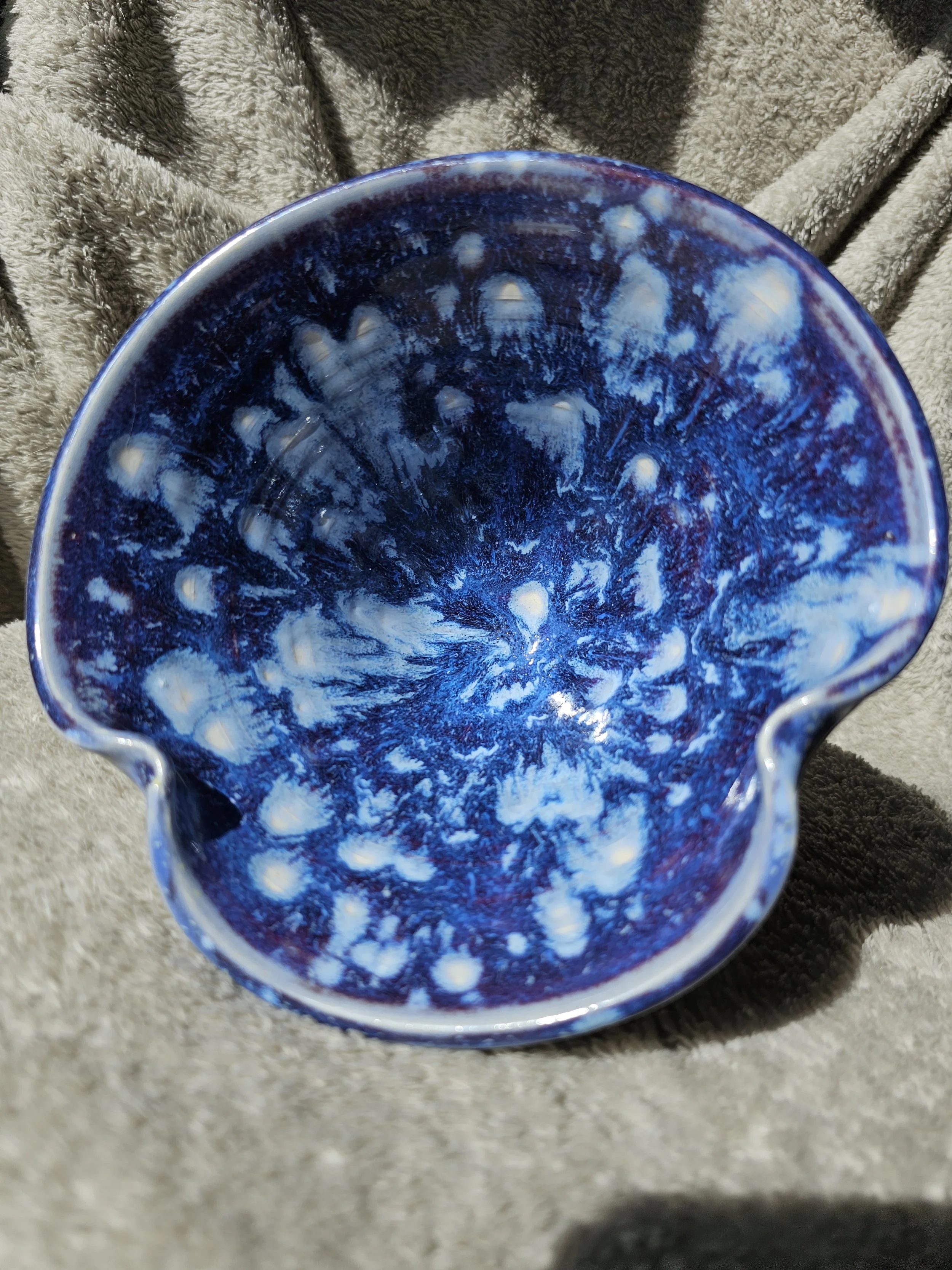 A ceramic pitcher with a blue and white swirl pattern.