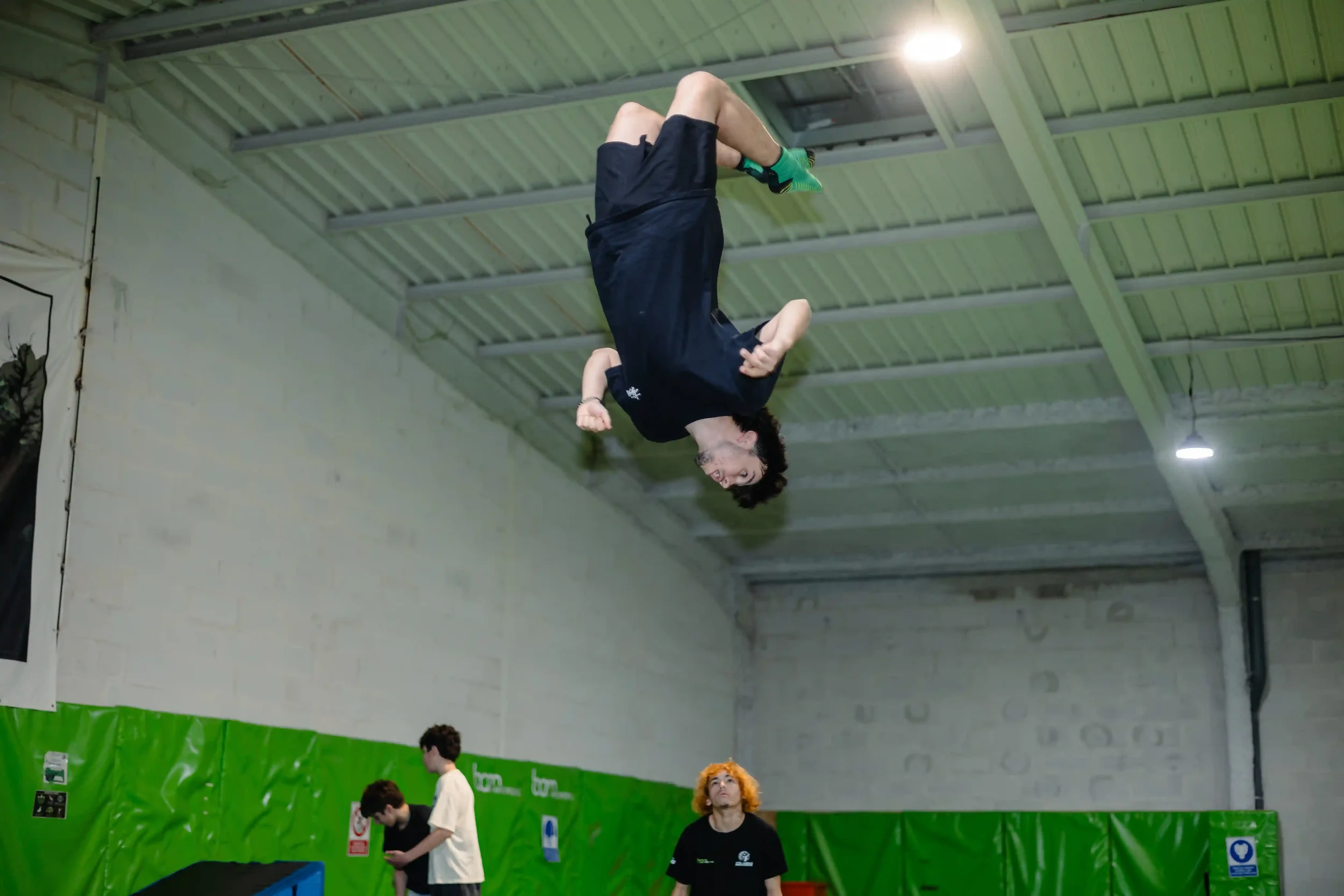 Jeune homme qui fait un salto devant ses amis à BAM FREESPORTS Chambéry