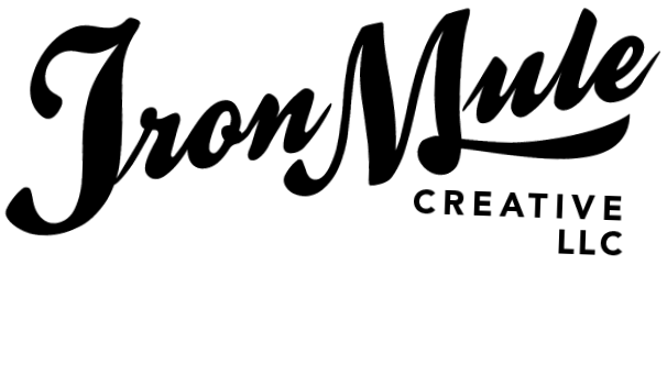 A silhouette of a man standing on a ledge with a city skyline and a large moon in the background.