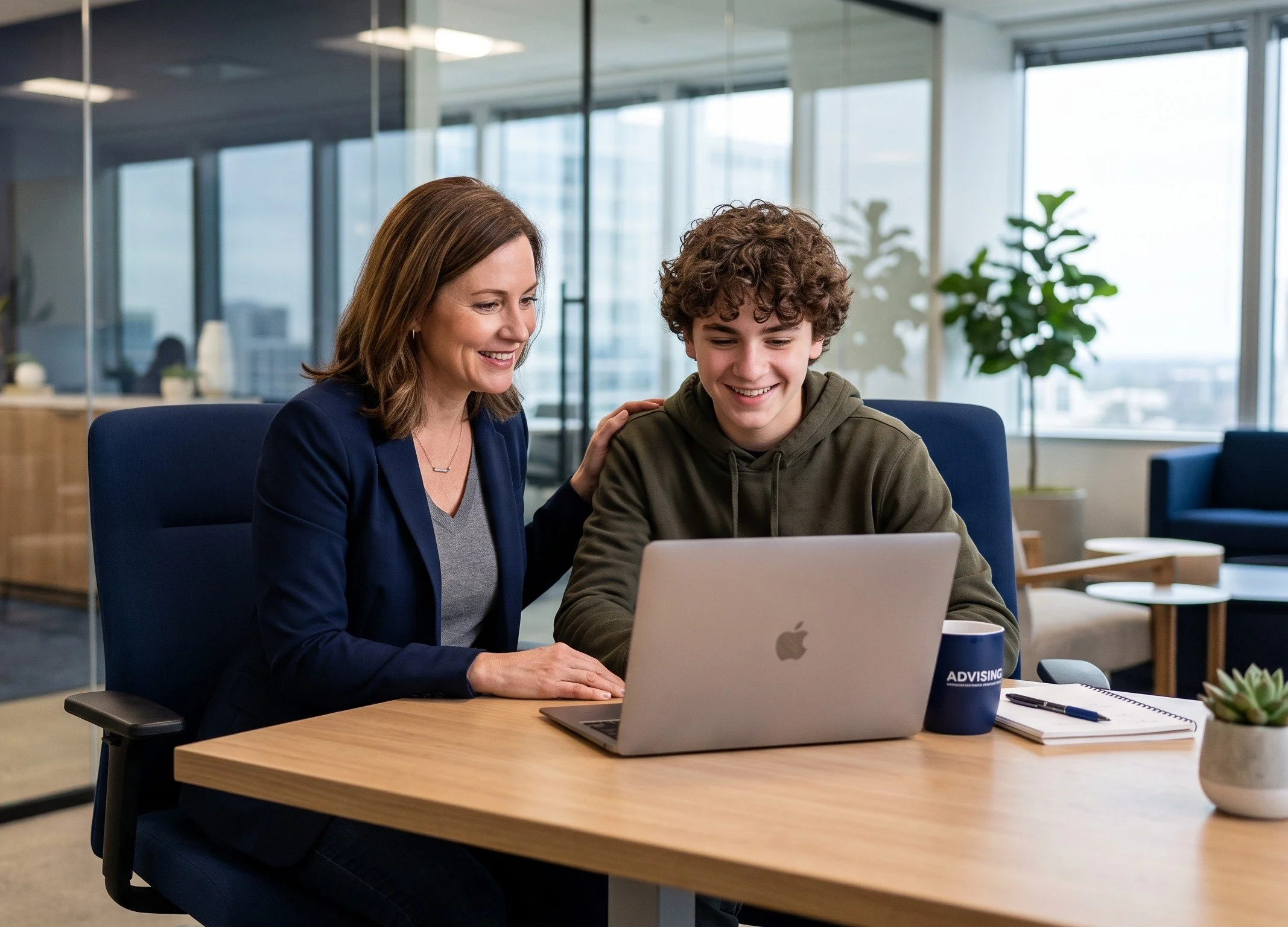 An Arkstone Career Strategy executive coach sitting with a teenager in a modern office, collaboratively reviewing a data-backed college and career launch plan on a laptop.