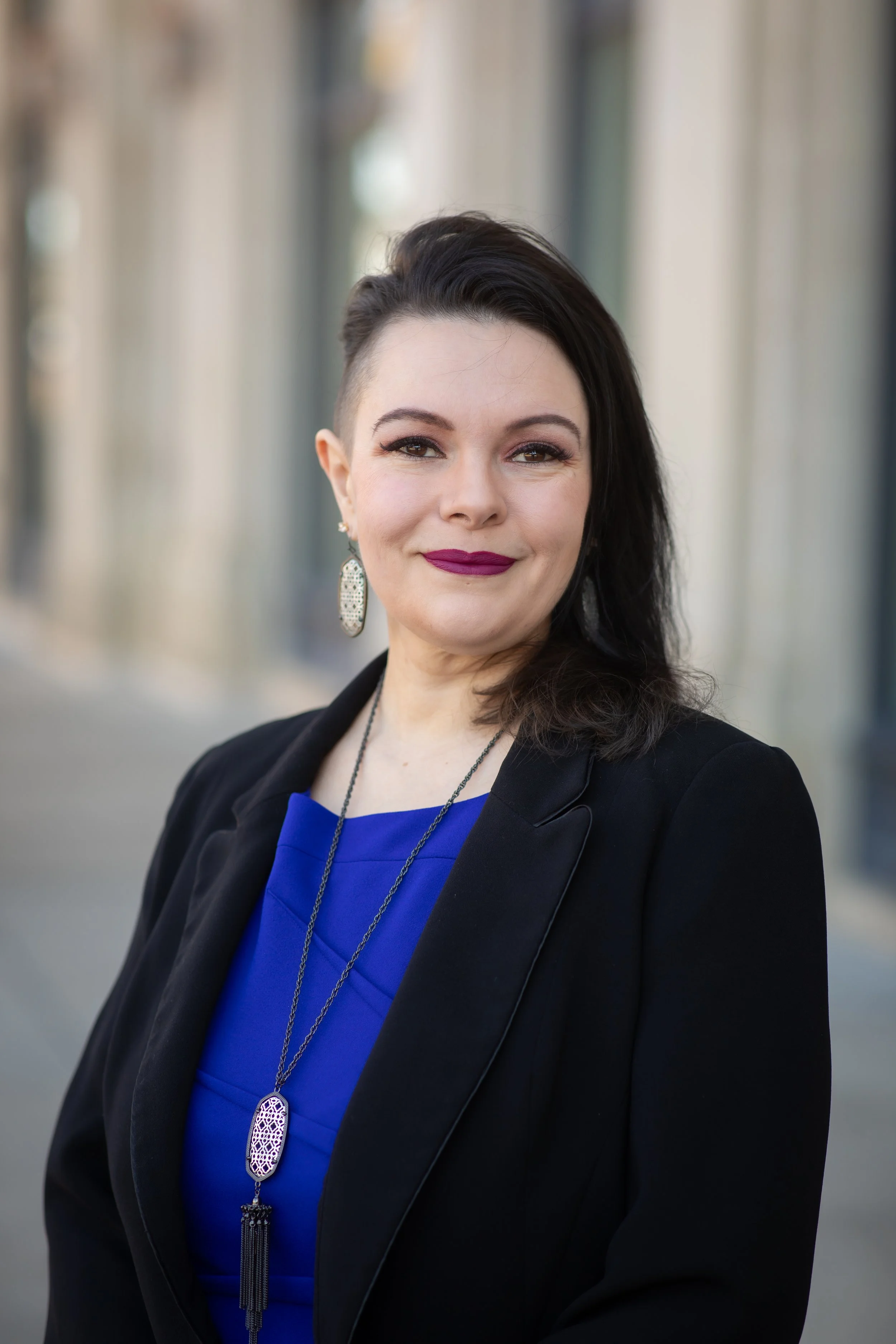 Rebecca Wilson, corporate IT Director and executive career strategist at Arkstone, standing professionally in front of modern glass architecture.