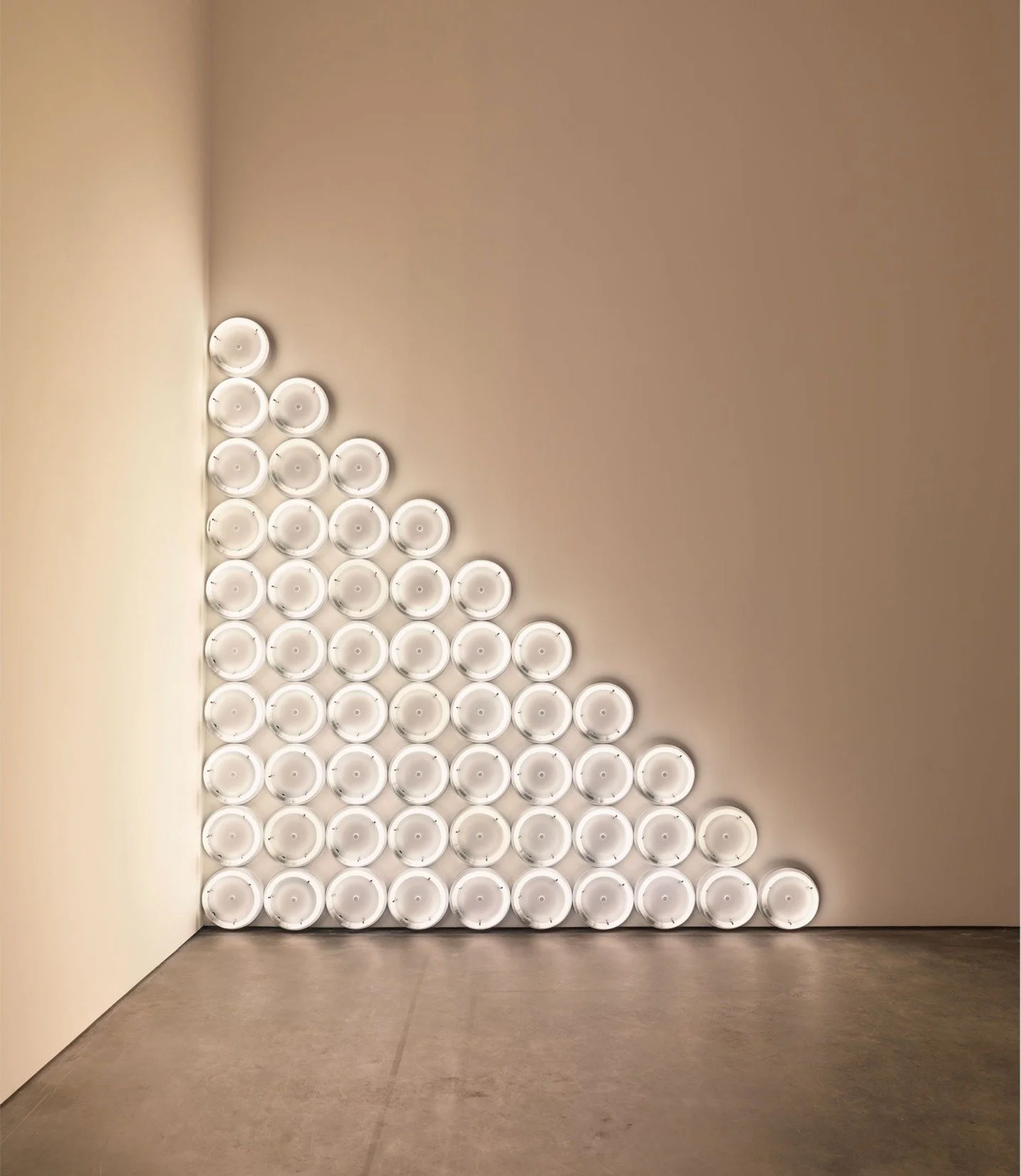 "untitled (to a man, George McGovern) 2" &mdash; Dan Flavin, 1972
Warm white fluorescent light, edition of 3

A cascade of 55 circular fluorescent fixtures arranged in a large right-angled triangle, this is one of Dan Flavin's most formally