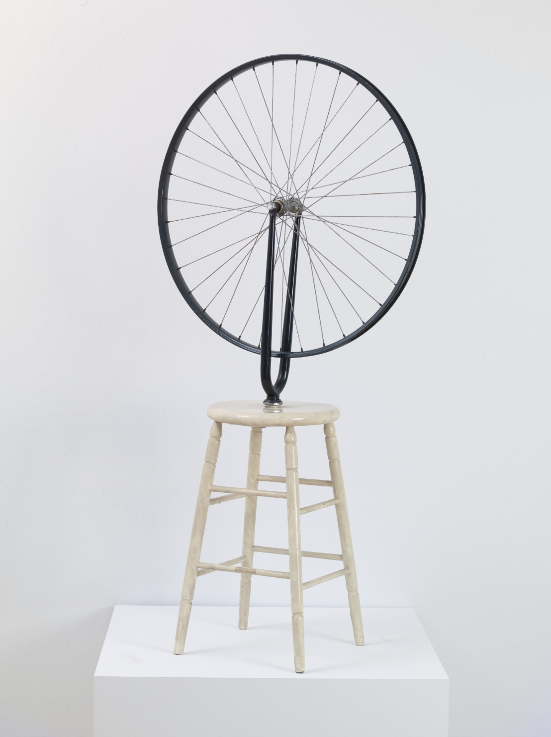 "Duchamp's Bicycle Wheel readymade, mounted upside-down on a wooden stool"