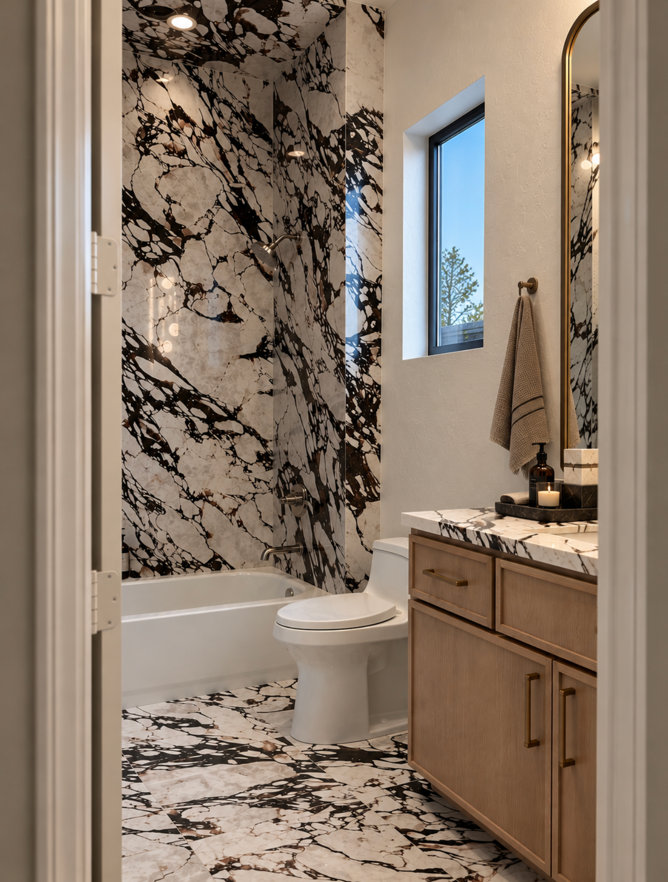 Interior alcove with boldly patterned stone feature surface, light wood cabinetry, decorative branches and framed wall art.