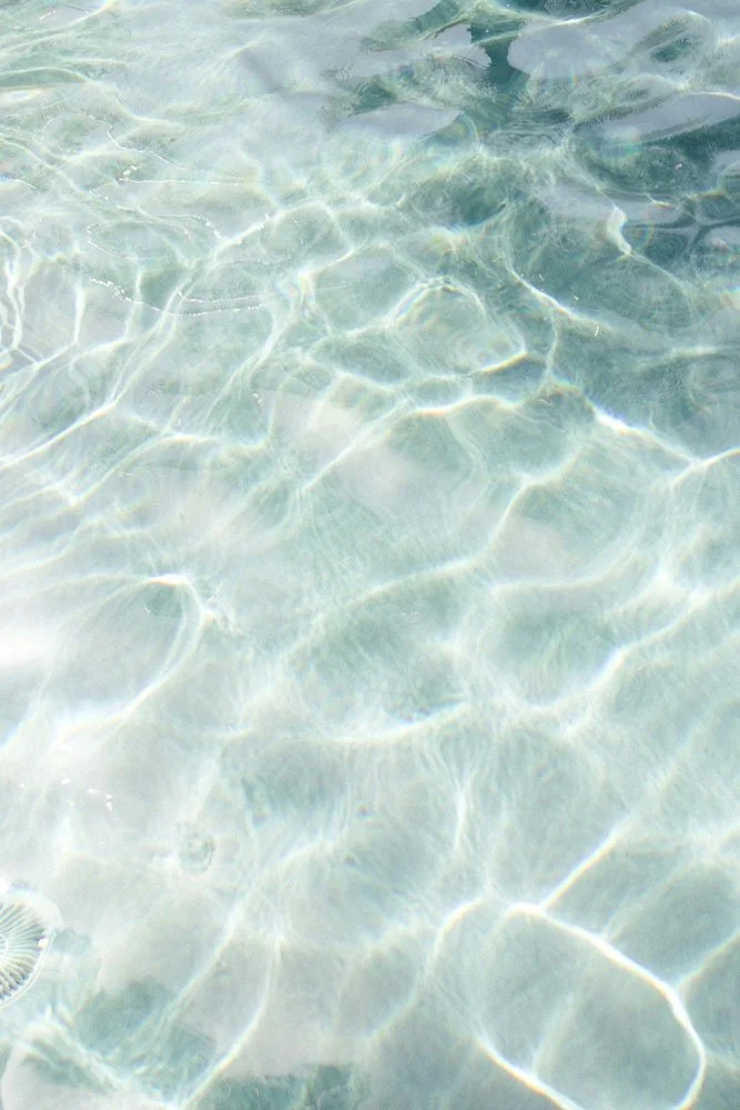 Clear water with sunlight reflecting on the surface.