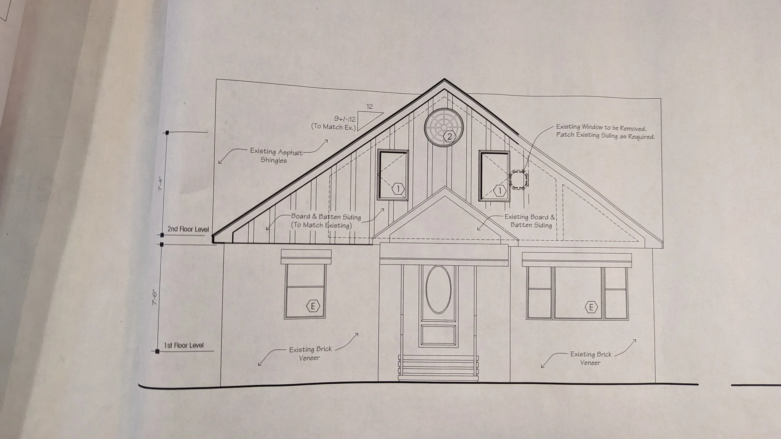Architectural blueprint of a house's front elevation showing windows, doors, roofing with asphalt shingles, and exterior wall details.
