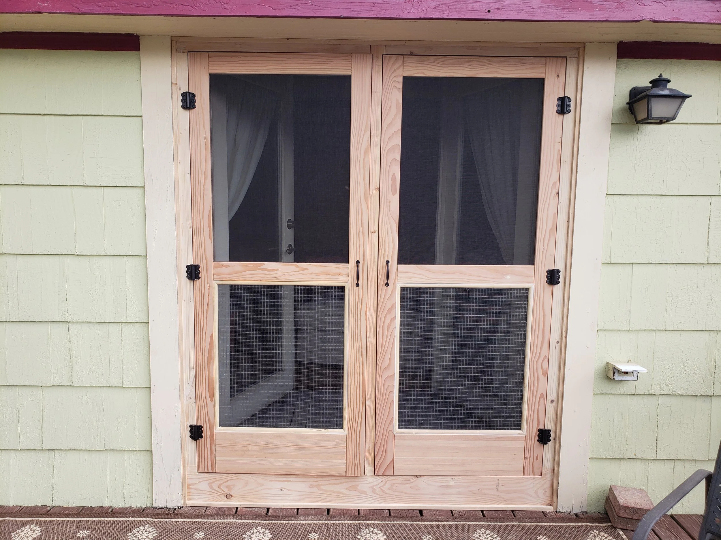 Unfinished wooden porch door with ascreen.