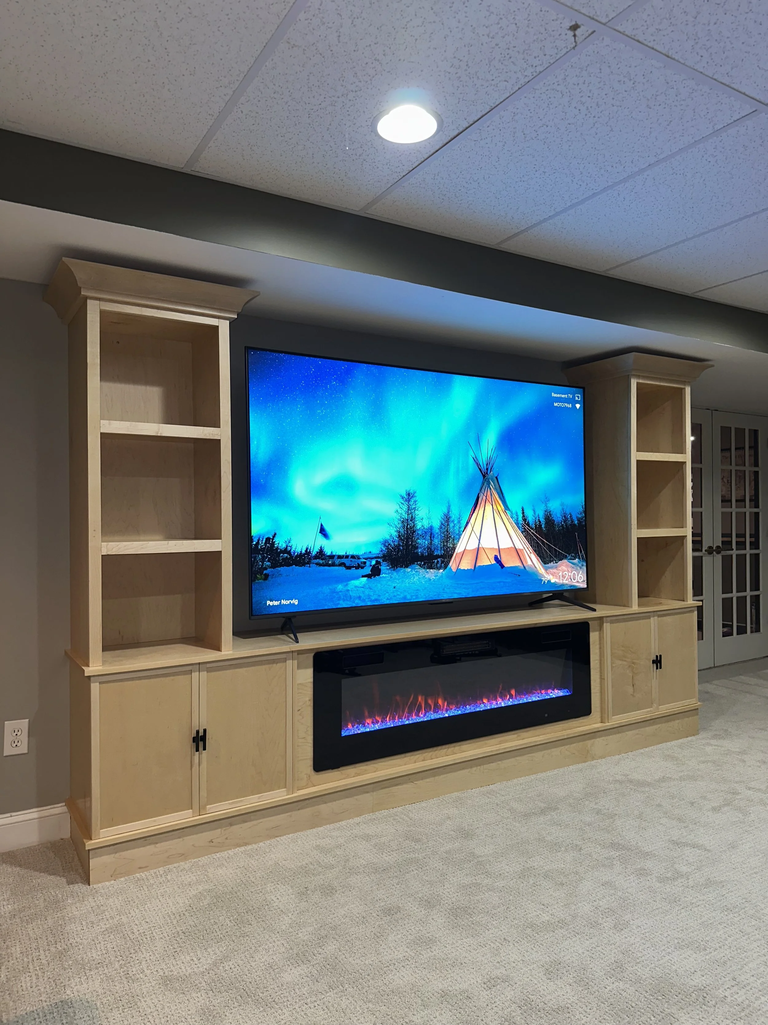 Custom maple built-in entertainment center with electric fireplace