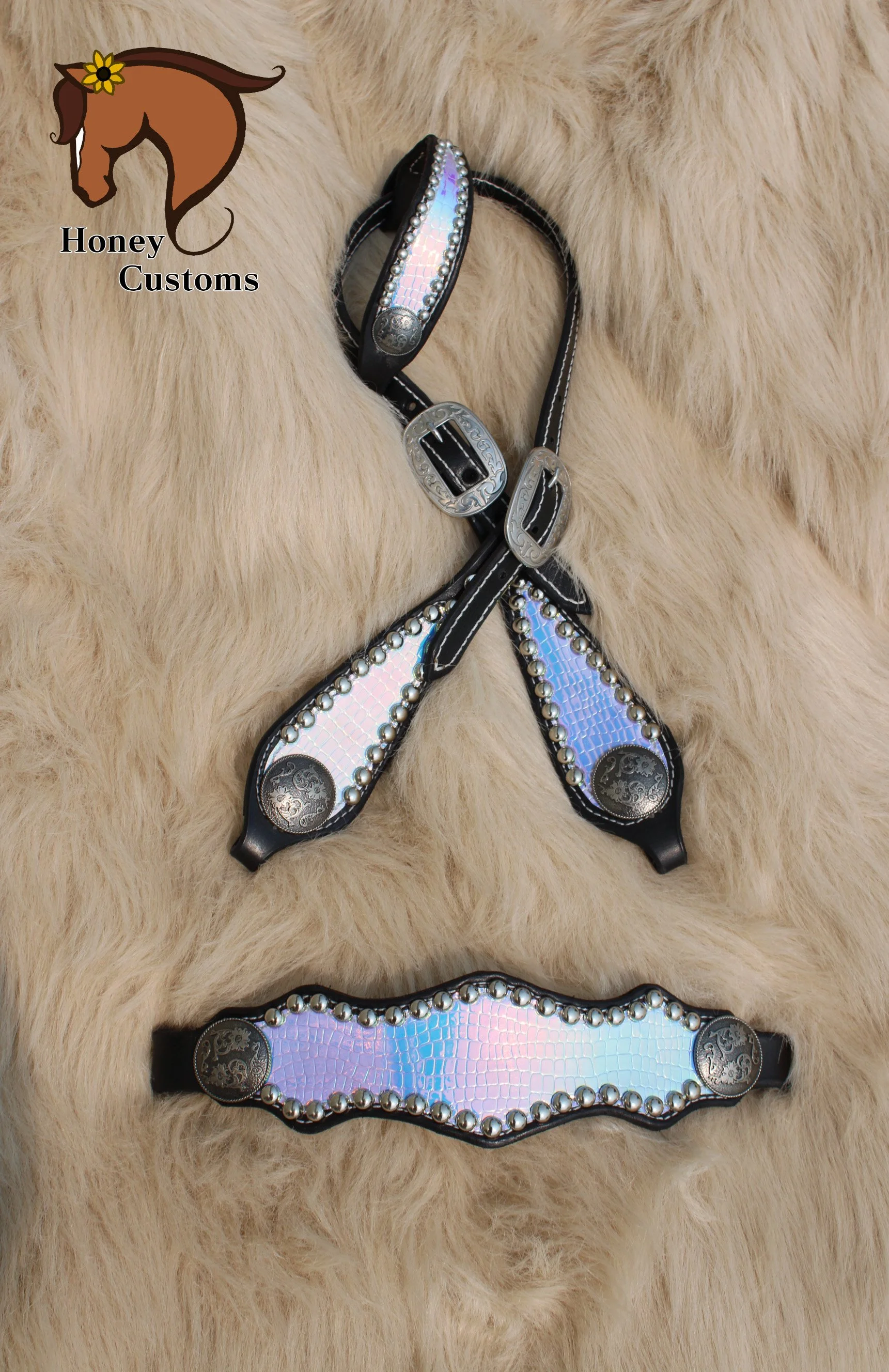 Close-up of decorative horse halters with rhinestones and silver accents on a cream-colored fur background, with a logo of a horse head and yellow flower labeled 'Honey Customs' in the upper left corner.