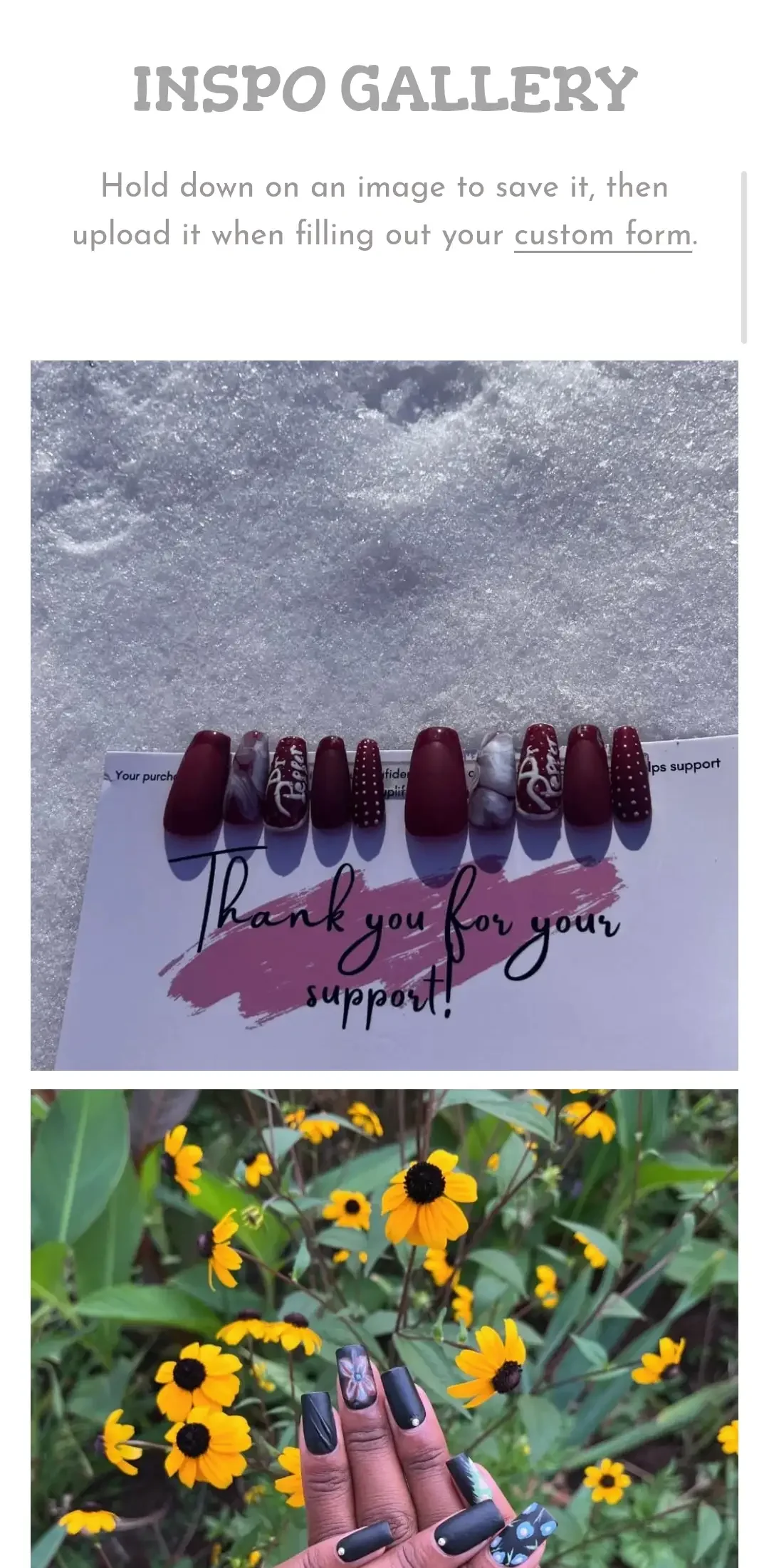 Photo of a thank you card with artificial nails laid on snow at the top of the card. A person holding a hand with black matte nails, some with floral and dot designs, positioned in front of yellow flowers at the bottom.