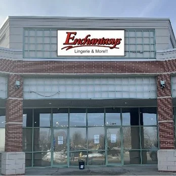 Exterior of a storefront with a sign that reads 'Enchantrays Lingerie & More!!'