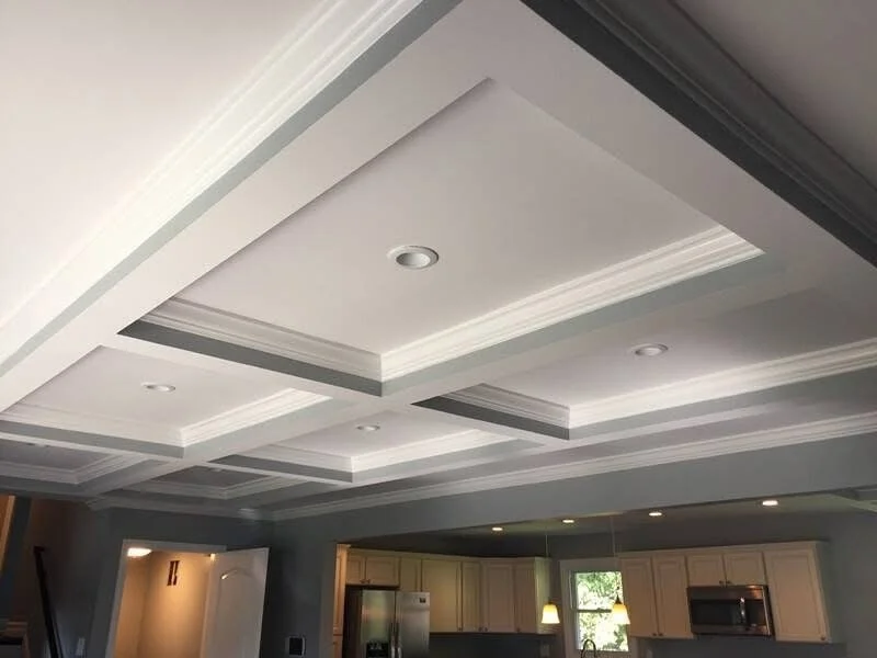 Ceiling with recessed lighting and layered crown molding in a modern kitchen