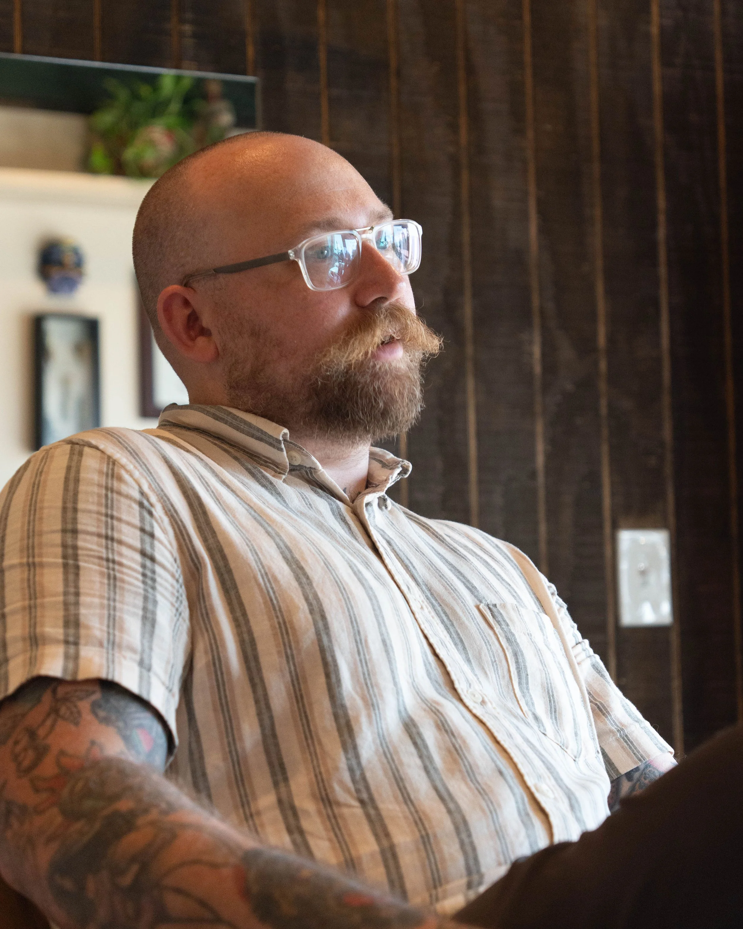 owner of Birdy's barbershop sitting in a barber chair