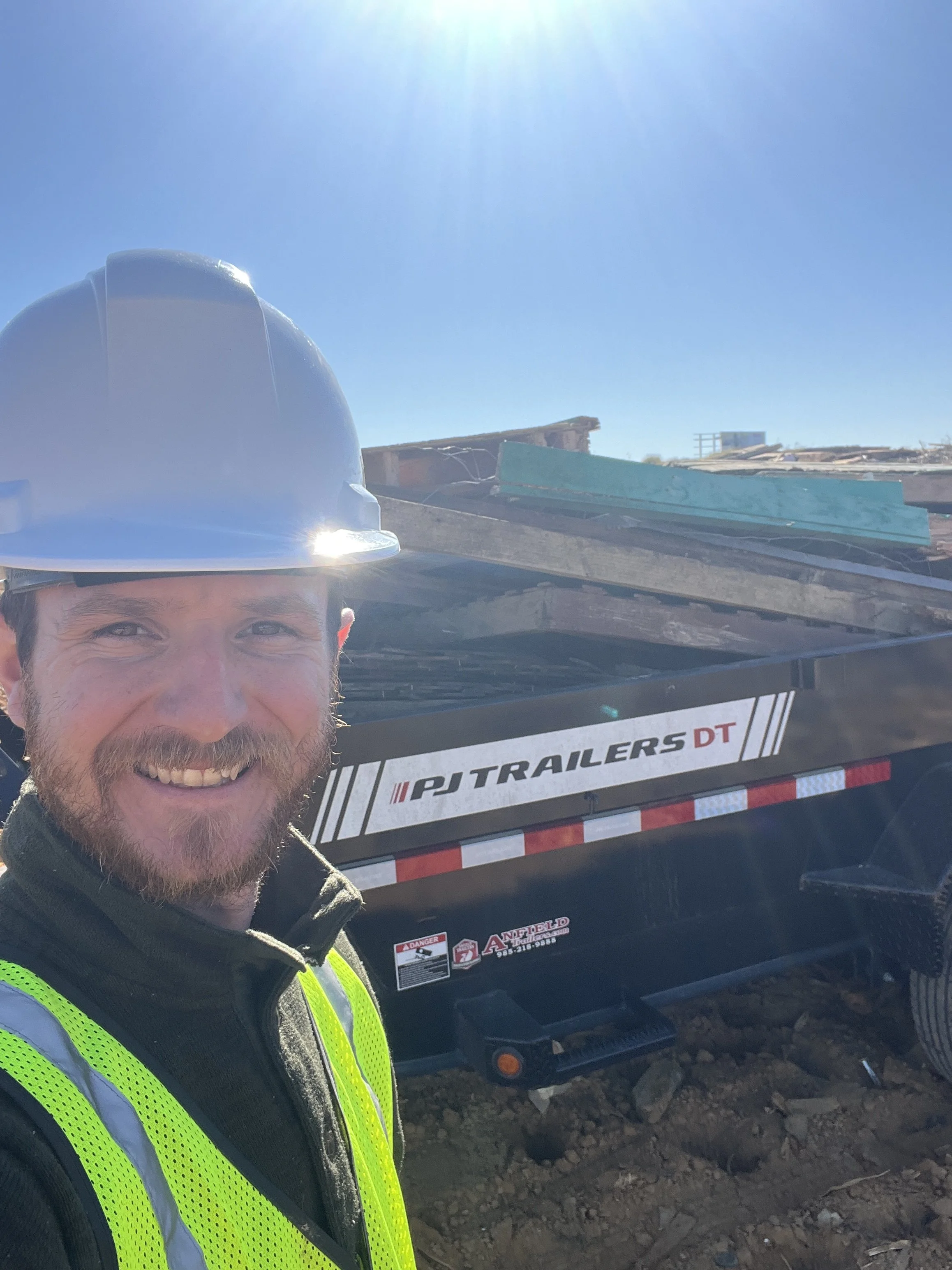 man standing by dumpster at landfill in Harrison County Ms