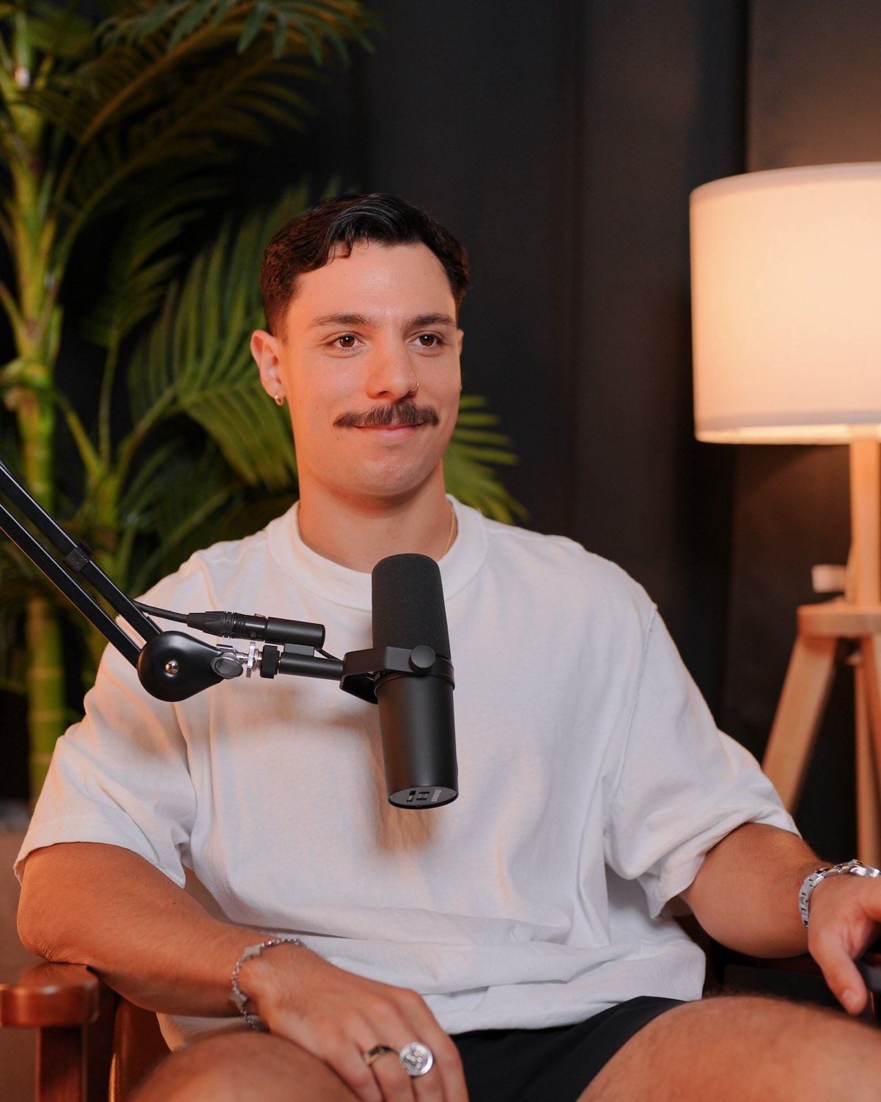 A man seated at a broadcast mic during a podcast session at Noble Frequency studio in Temecula–Murrieta.