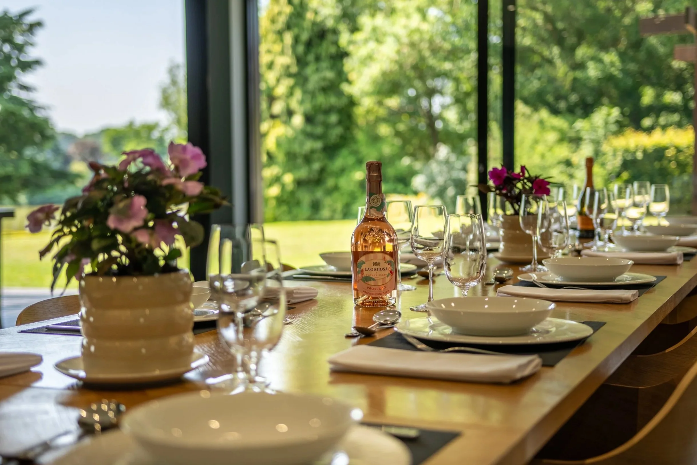 A long table with sparkling wine ready to host guests