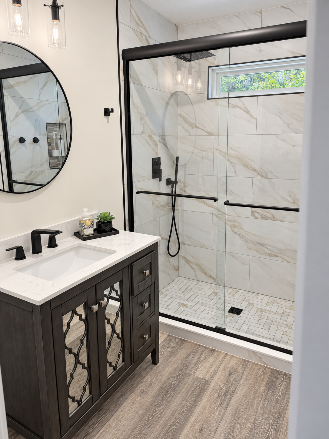Bathroom with a dark wood vanity and a glass-enclosed walk-in shower.
