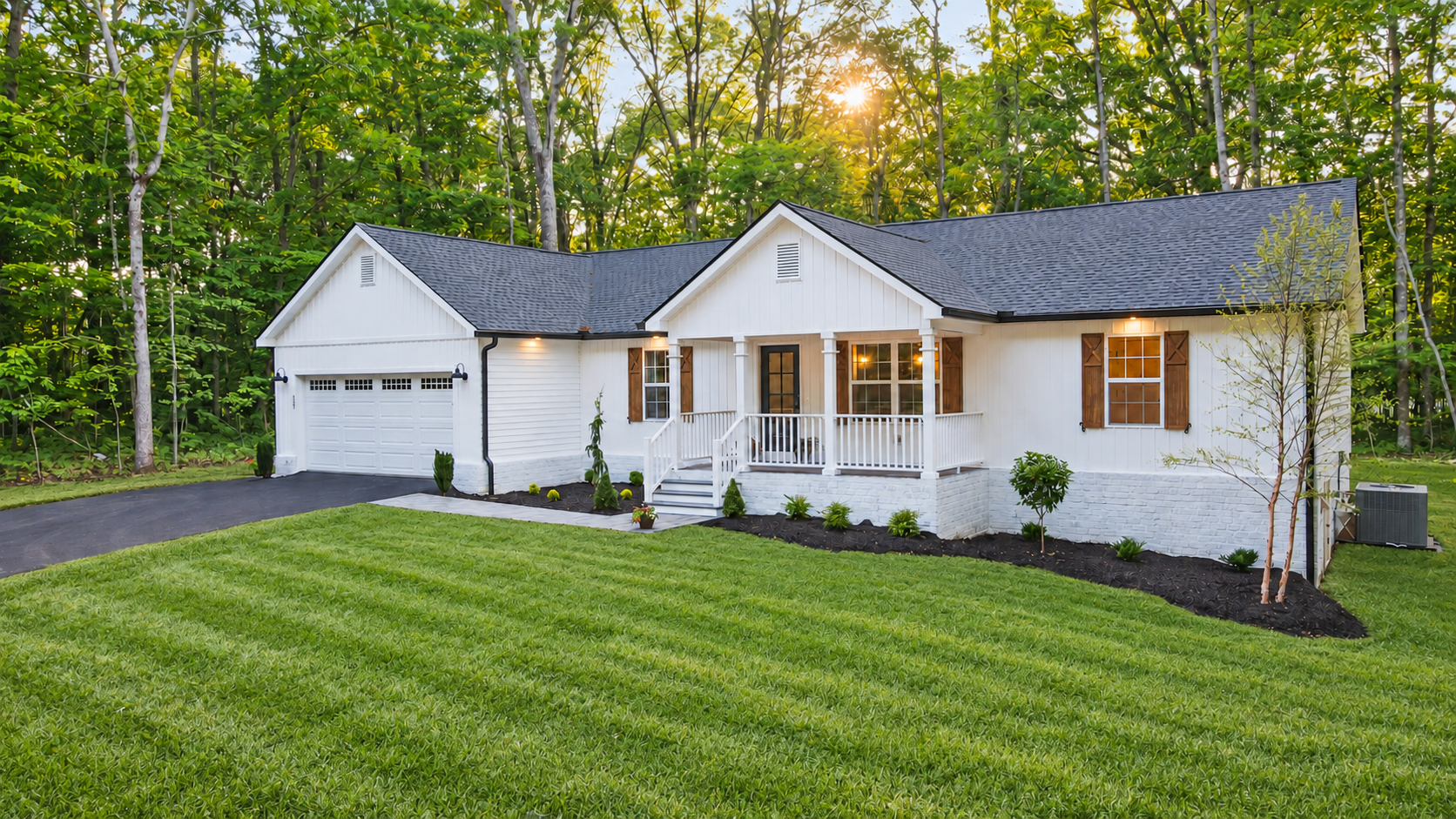 Exterior of the woodlands residence with white siding, a covered front porch, and a green lawn.