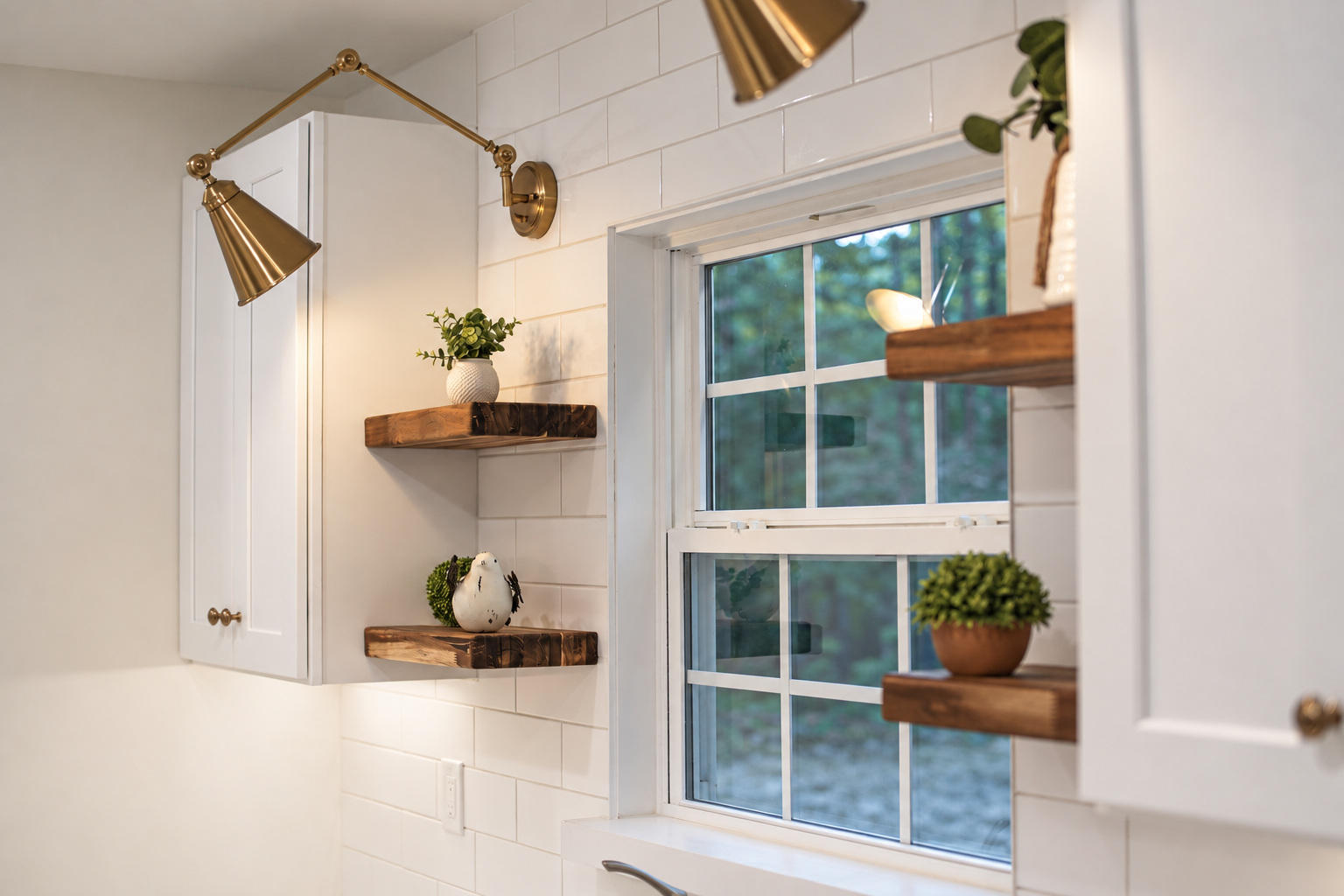 Kitchen window framed by white tile and wooden shelves with potted plants.