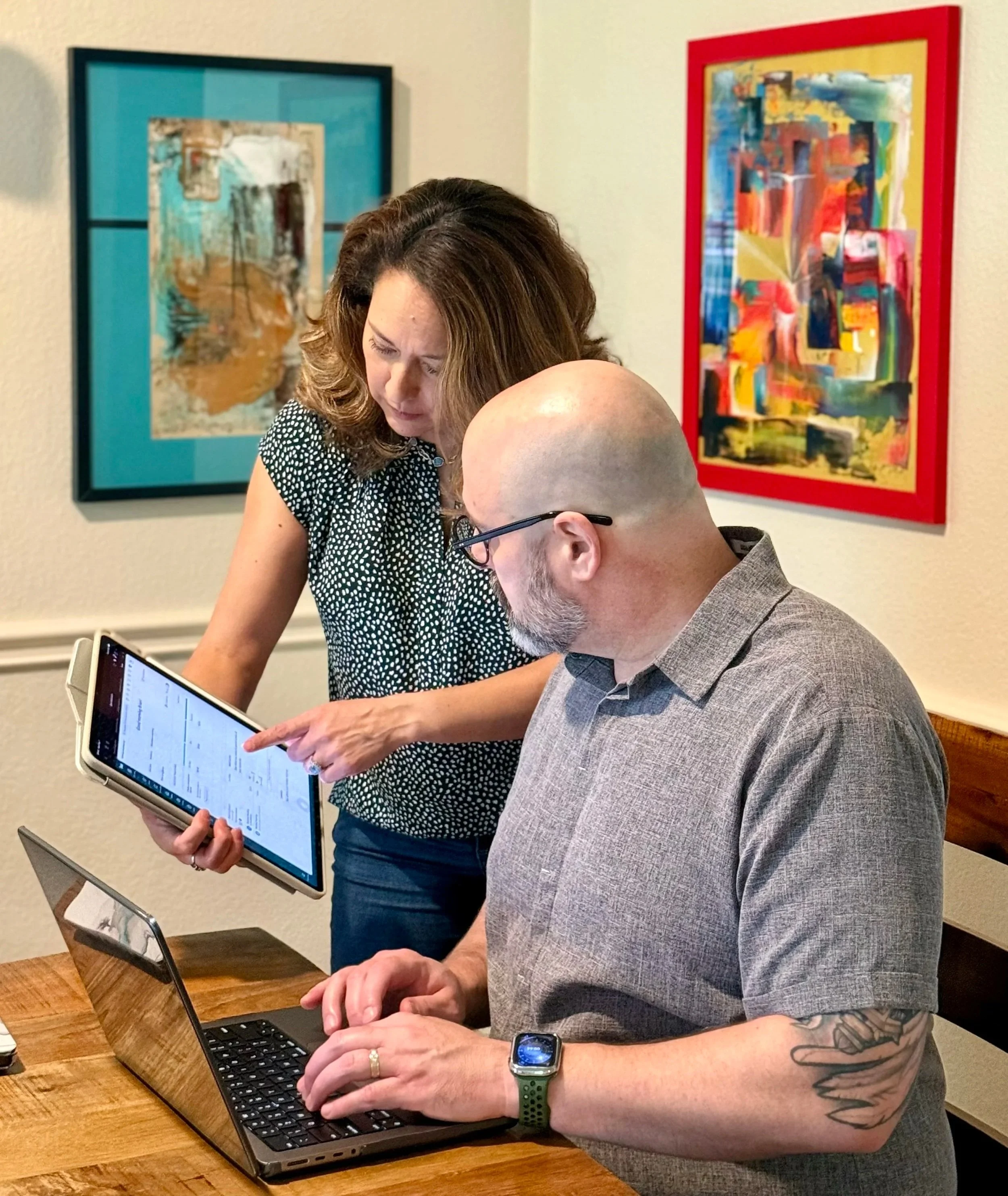 Vivian discussing a client's books with Brian.