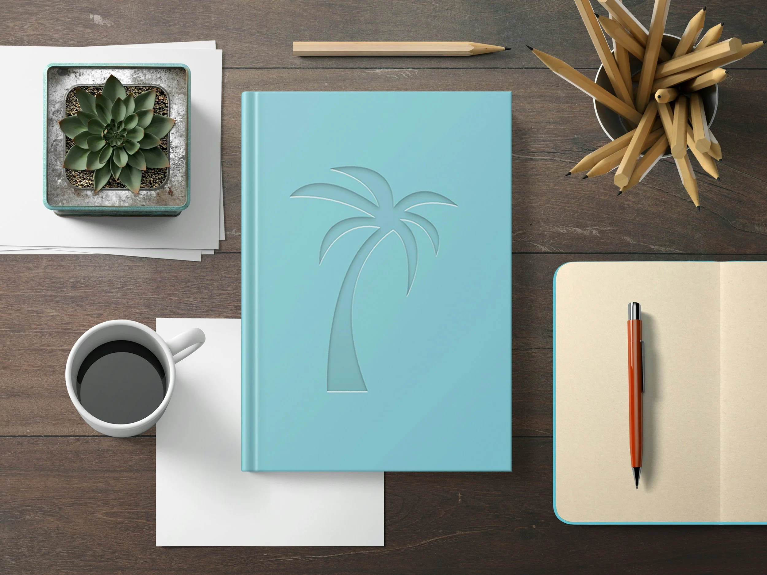 Top view of a workspace with a cup of coffee, a small potted succulent plant, white papers, a closed blue notebook with a palm tree design, a yellow notepad, an orange and black pen, and a black cup filled with wooden pencils on a wooden surface.