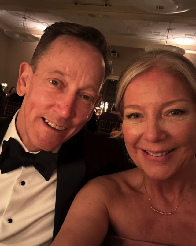 A client wearing a pink sapphire necklace at a wedding
