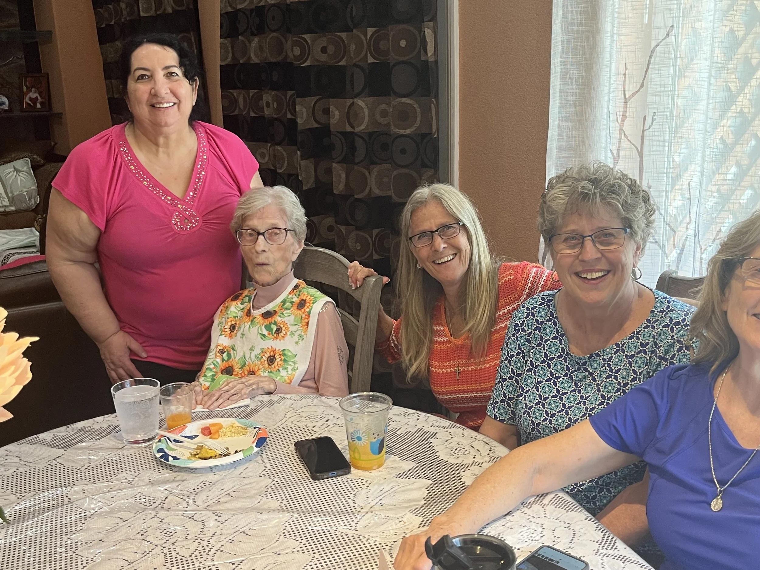Maria licensed nurse with resident and family at lunch