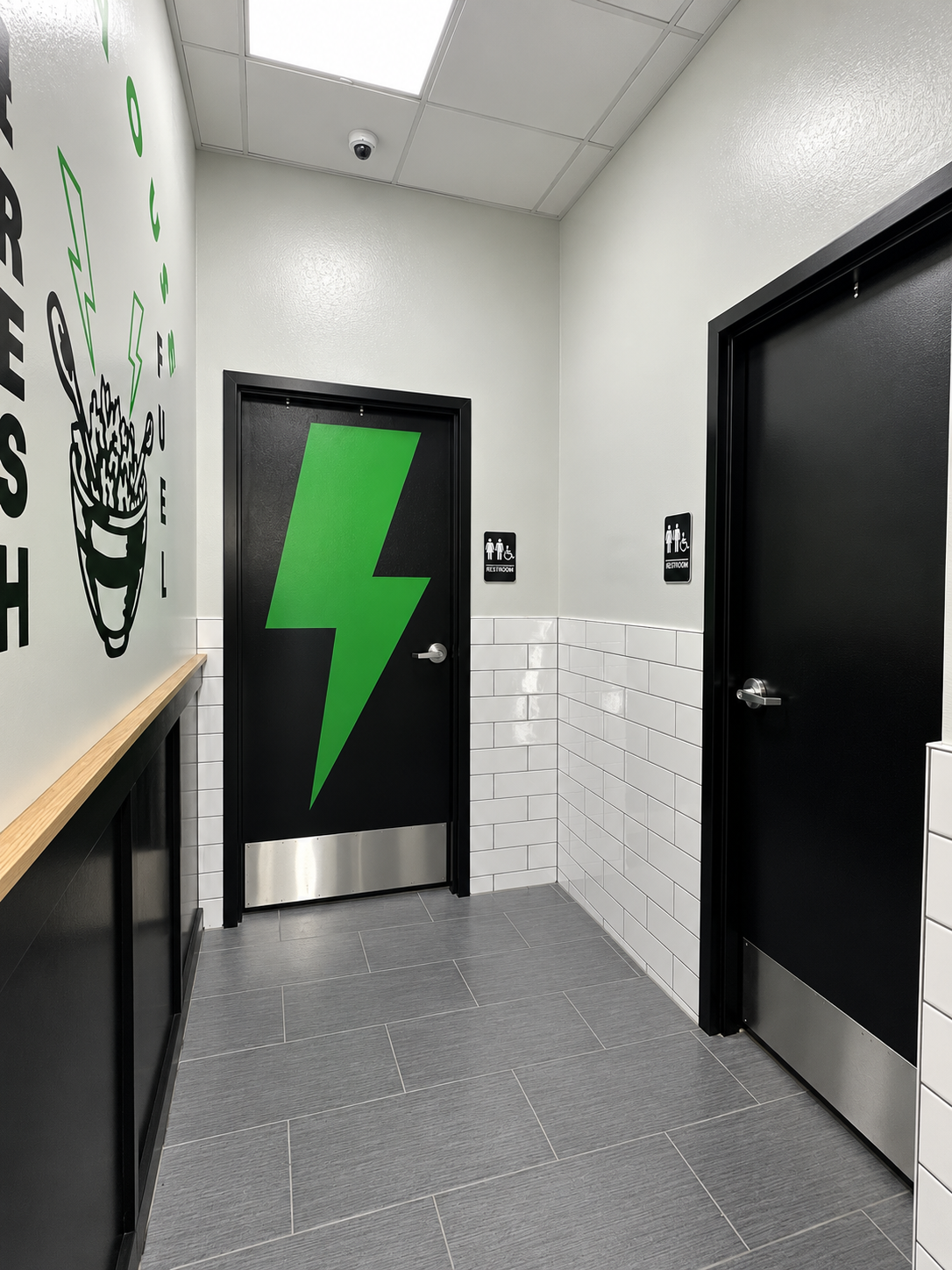 Modern Restroom Corridor with Green Accents.png
