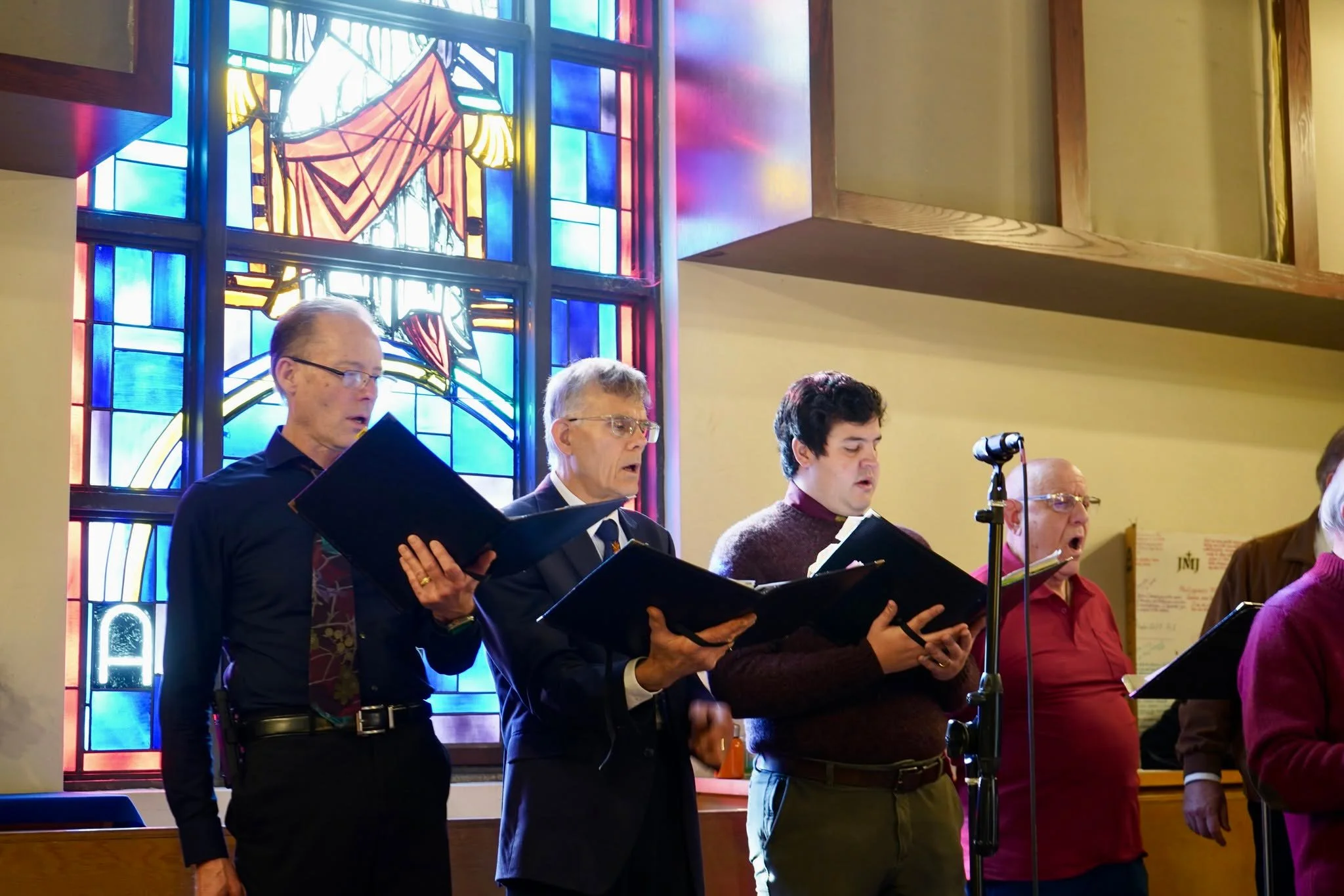 A group of men singing in the St Eugene choir