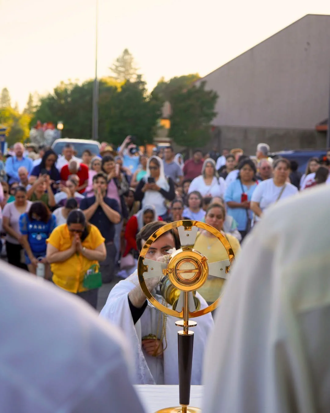 A priest holding a monstrance during a Eucharistic procession in Santa Rosa