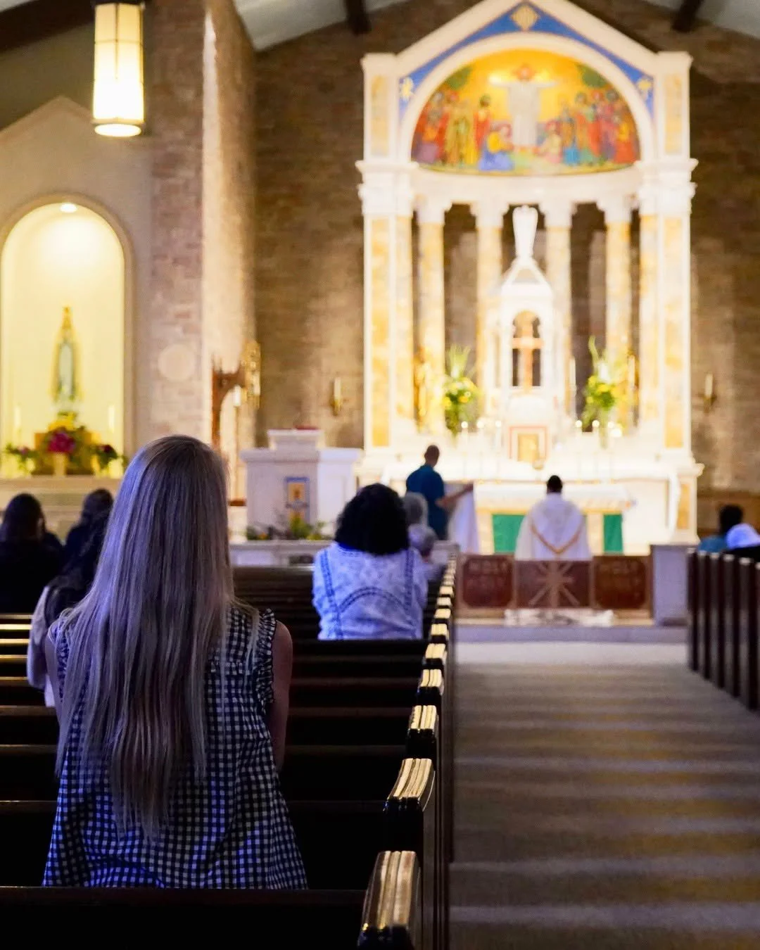 People praying inside the Cathedral of St Eugene