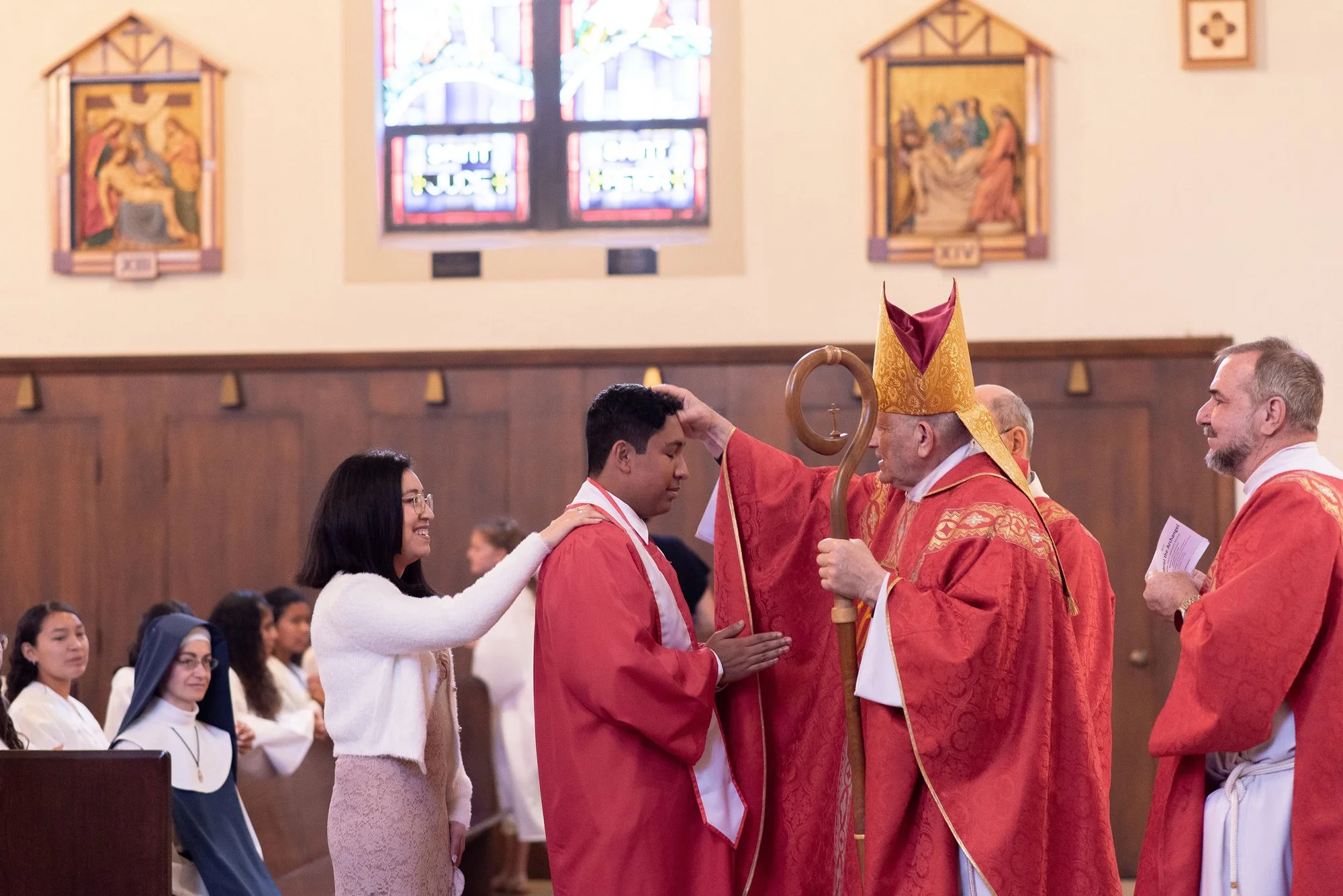 A young man receiving the sacrament of Confirmation at the Cathedral of St Eugene