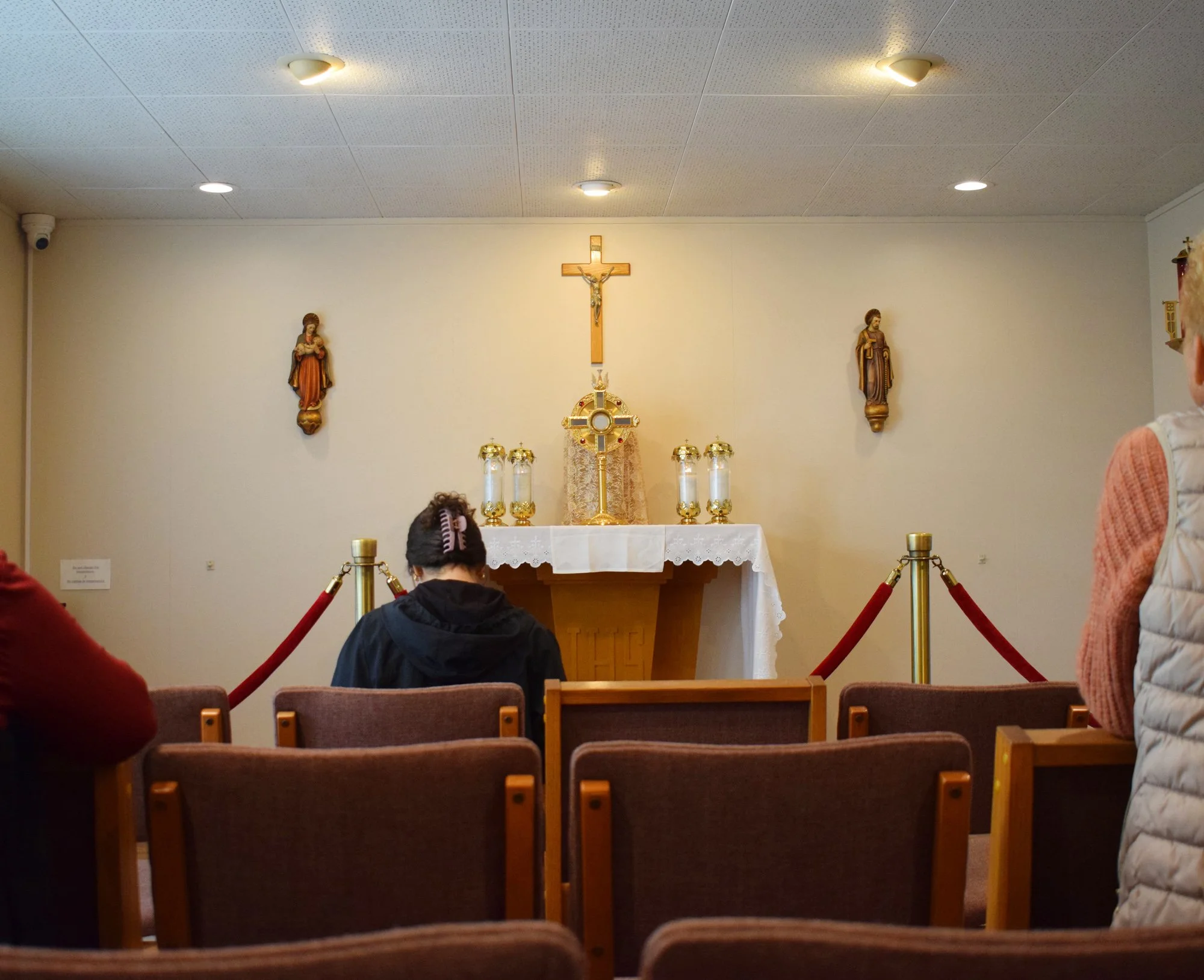 Women praying in St Eugene Adoration Chapel