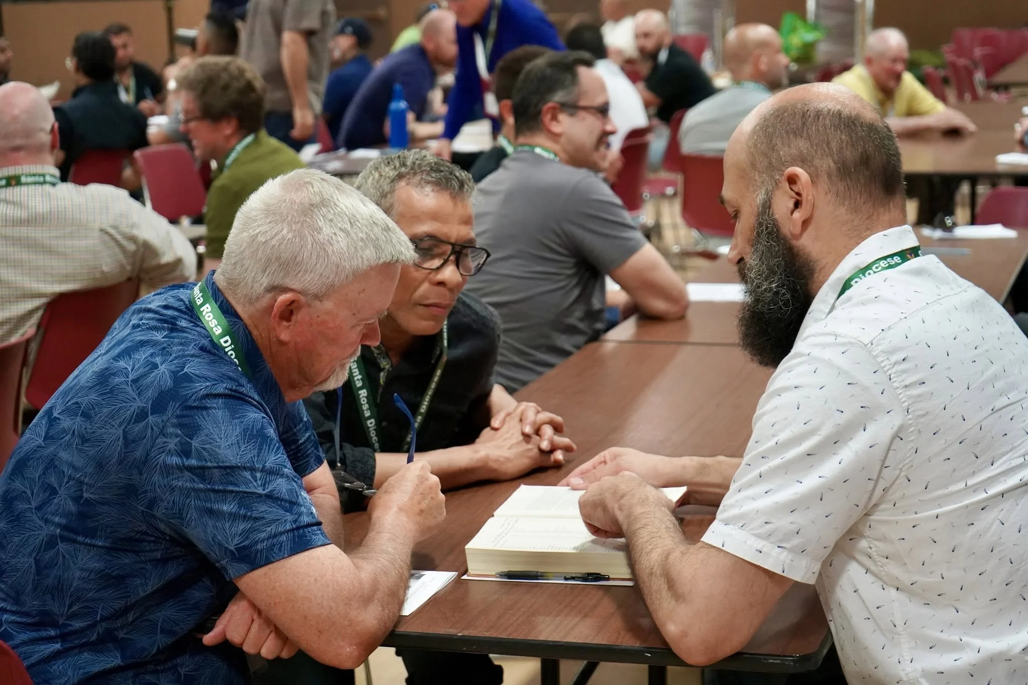 People engaging in Bible study at a conference at the Becker Center of the Cathedral of St Eugene