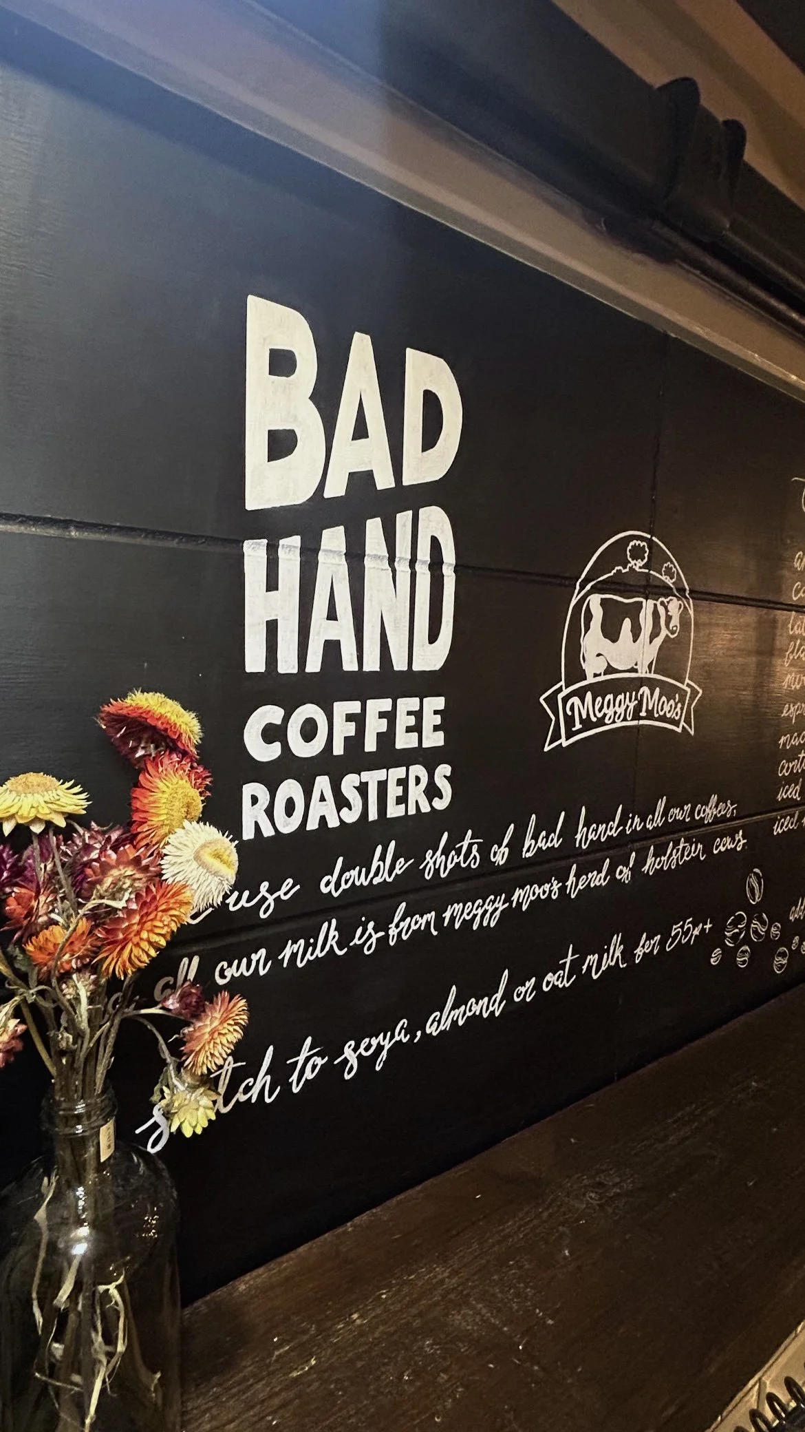 Bad Hand and Meggy Moo's logo as part of a larger chalkboard for Deans Court Cafe.