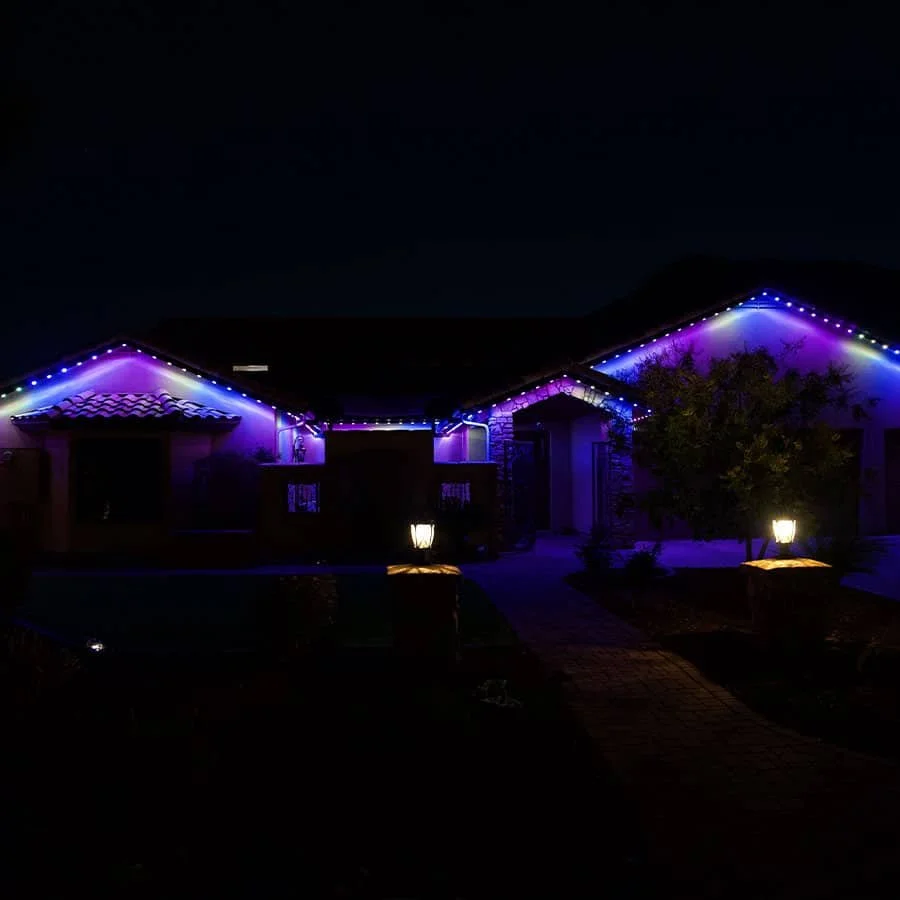 Permanent LED roofline lighting installed on a home at night in purple and blue. Orlando Permanent Lighting, Winter Park Holiday Lighting, Windermere Christmas Light Installation Near Me