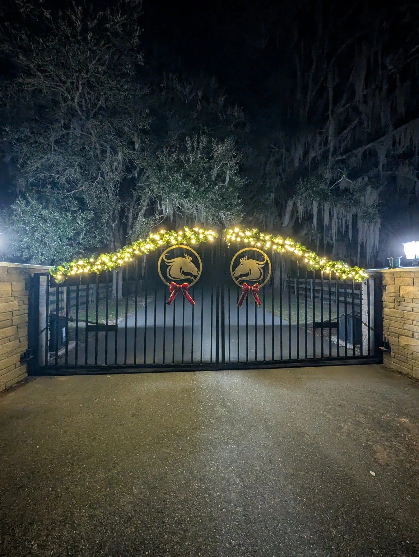 Christmas light installation on a decorative gate with illuminated signs in Isleworth