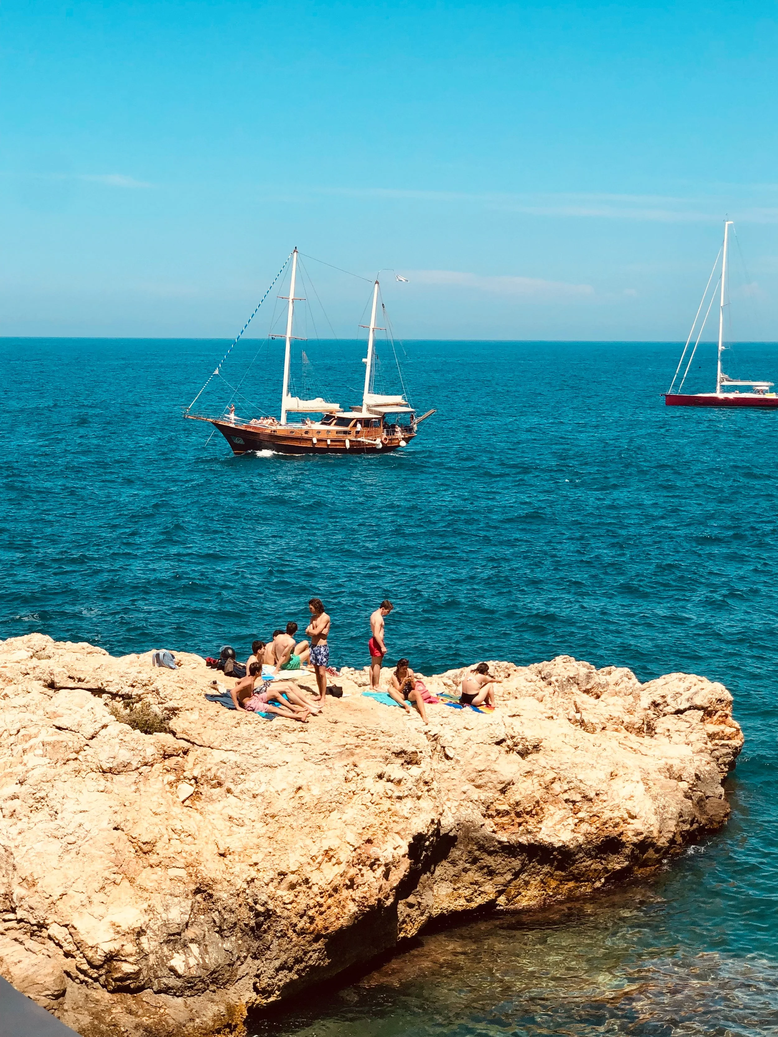 Swimmers enjoying a sunny at in Polignano al Mare, Puglia, Italy,