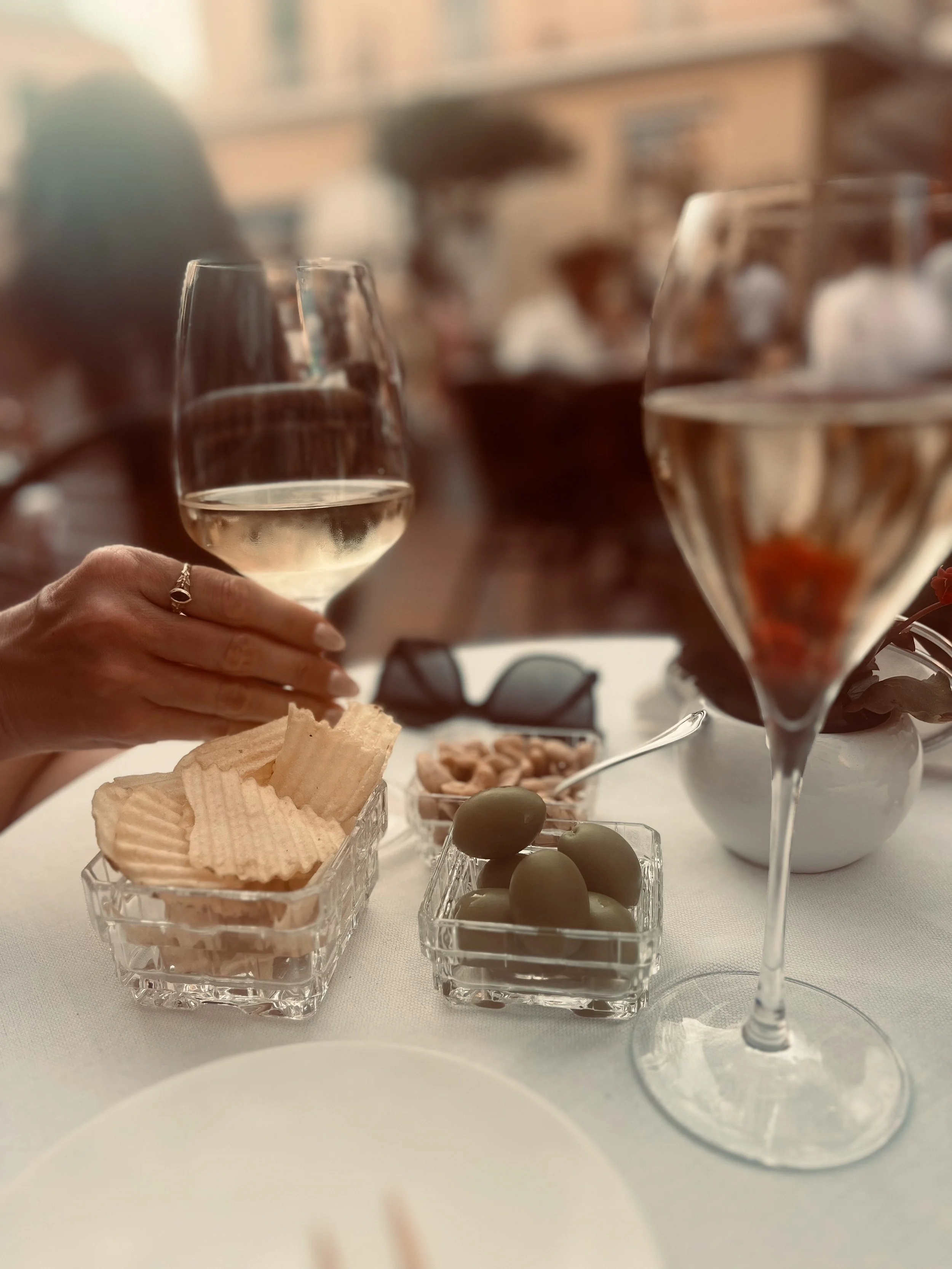 Enjoy prosecco and snacks during Aperitivo Hour on the patio of Capri's famous Grand Hotel Quisisana.