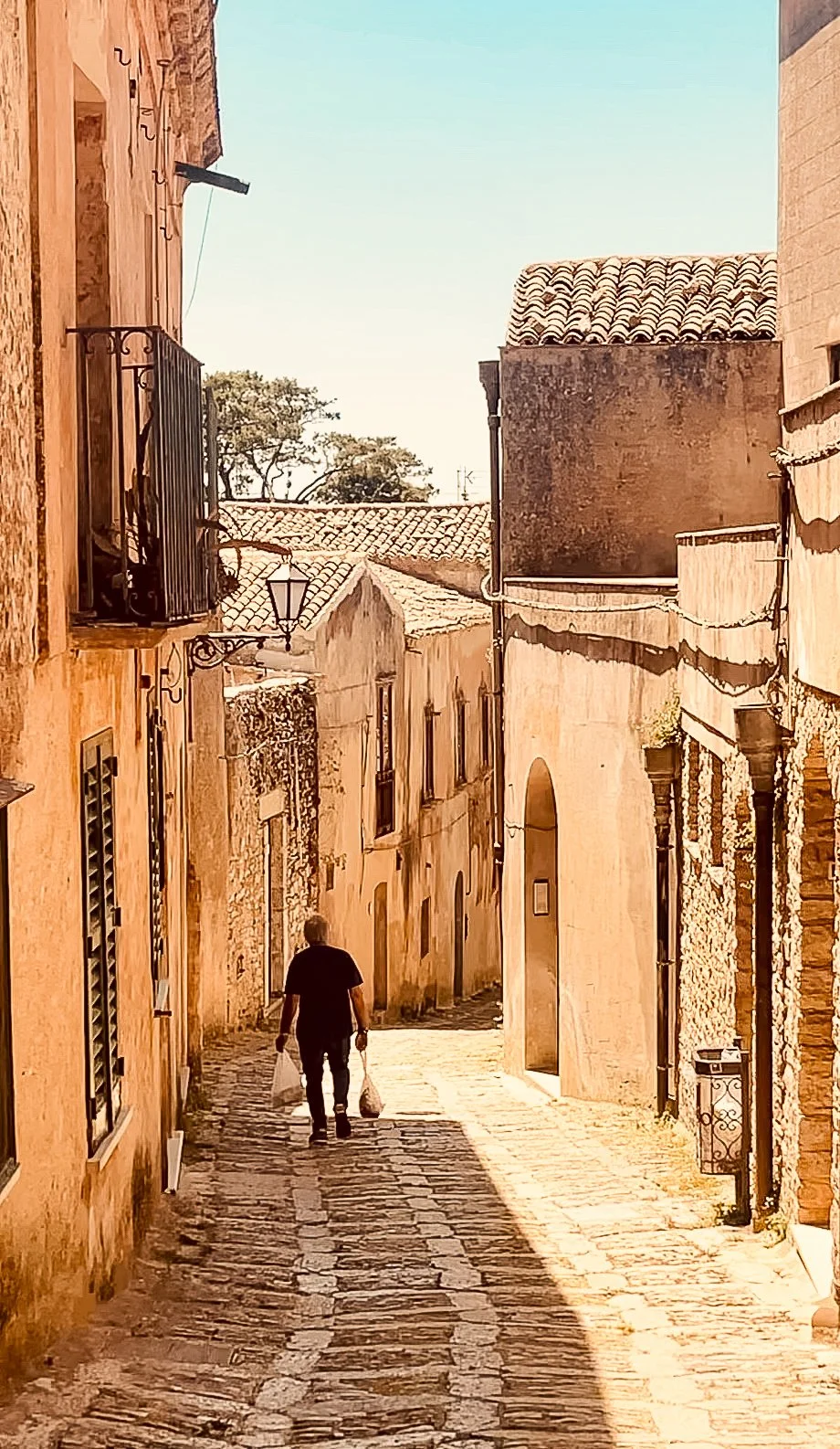 The warm-toned stone buildings and cobblestoned streets of Erice, Sicily, Italy.