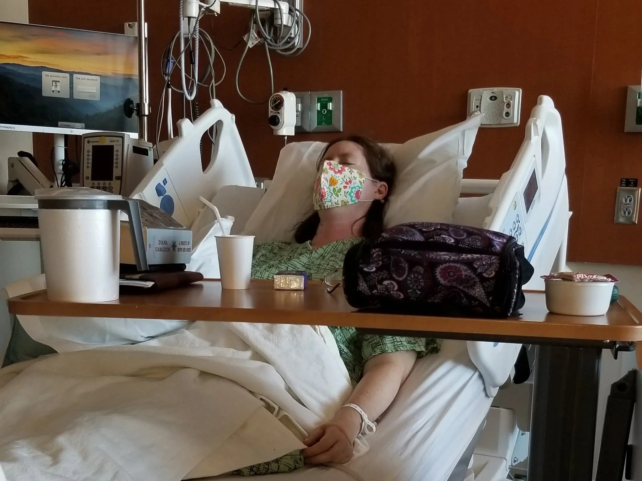 Amy sleeping in a hospital bed after surgery in October 2022