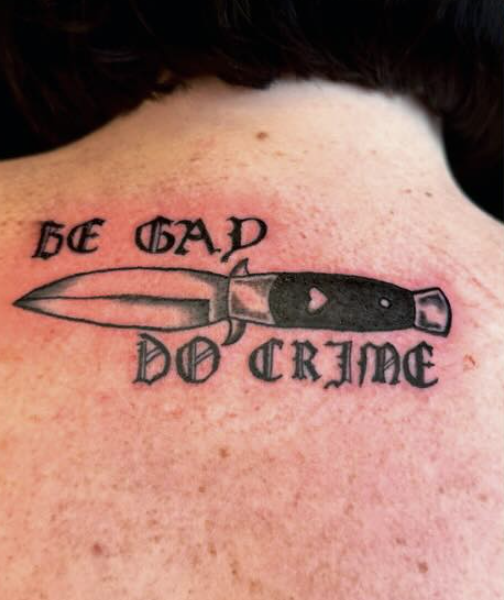 Tattoo of a dagger with the words 'BE GAD' above and 'DO CRIME' below.