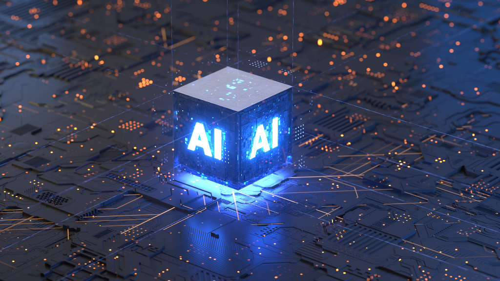 A glowing cube with the letters 'AI' on each side, set on a circuit board with glowing orange and blue lights, representing artificial intelligence technology.