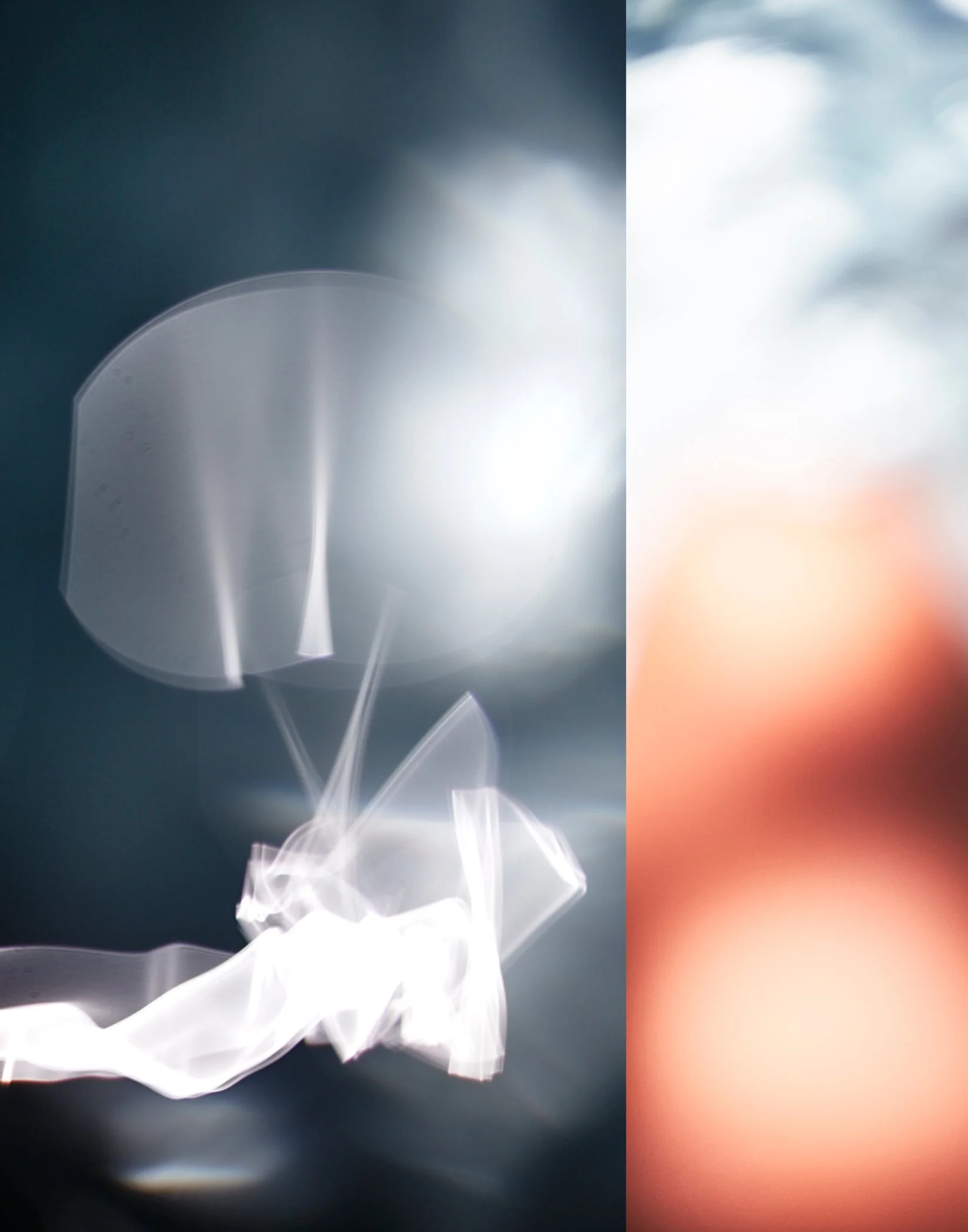 Abstract image with bright white and blue light streaks on the left, and a blurred, warm orange and gray background on the right.