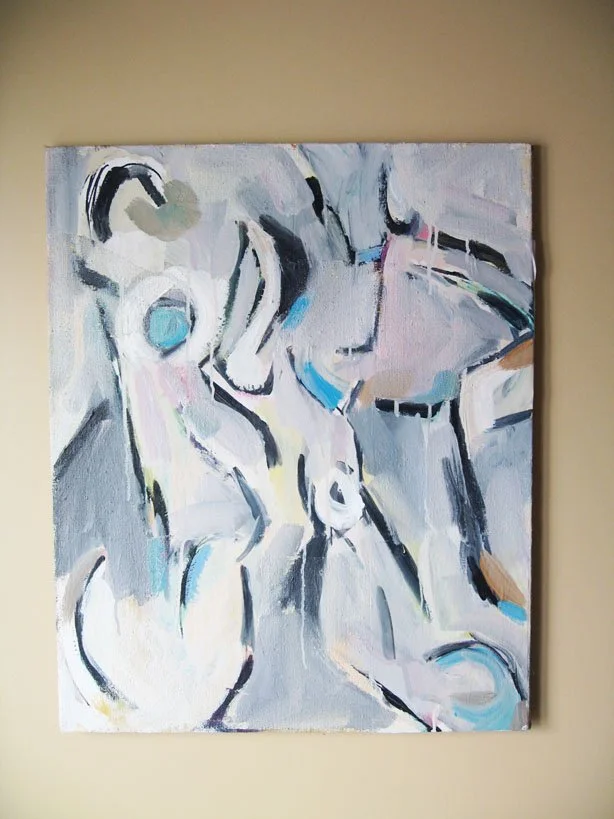 Abstract painting with swirling black, white, gray, and pastel colors on a beige wall.