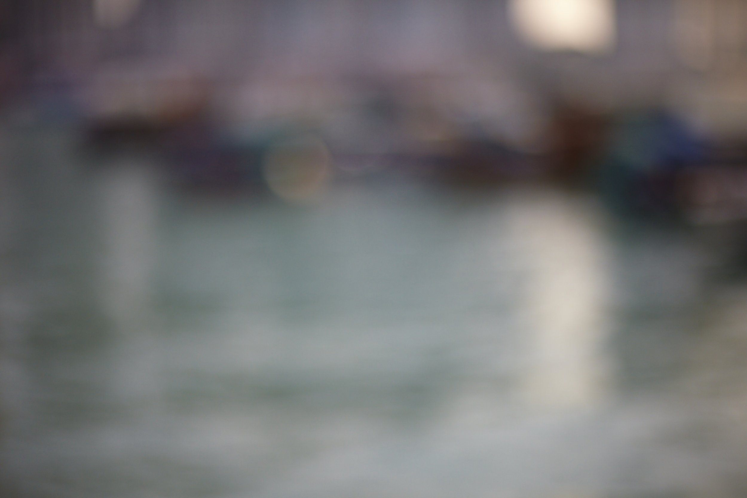 Blurred image with abstract colors and shapes, unclear subject.