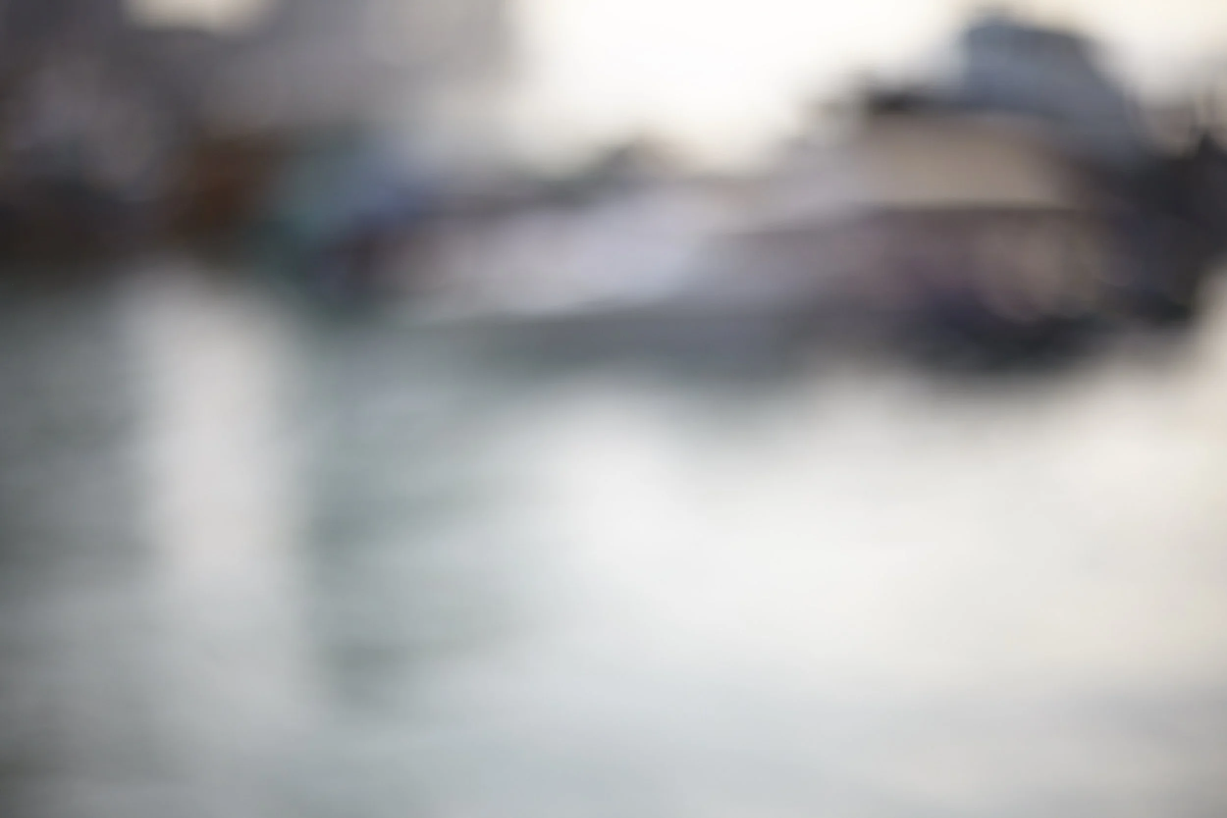 A blurry abstract image with indistinct shapes and colors.