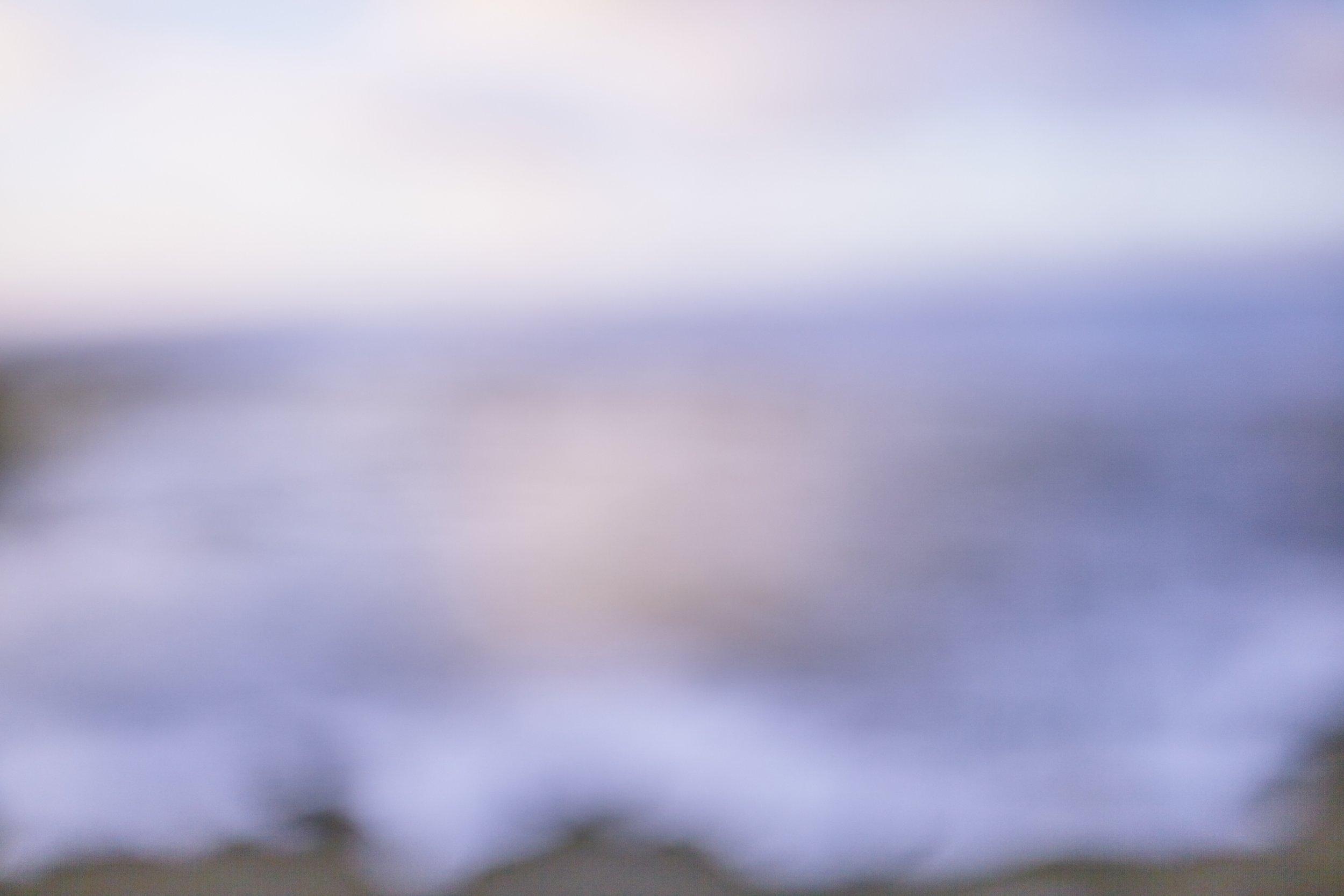 Abstract blurred scene with soft pastel colors and no distinct objects.