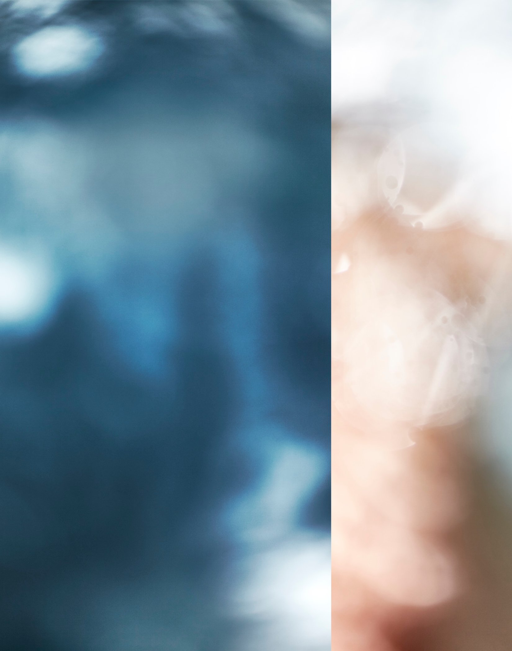 Abstract blurry background with shades of blue, white, and beige.